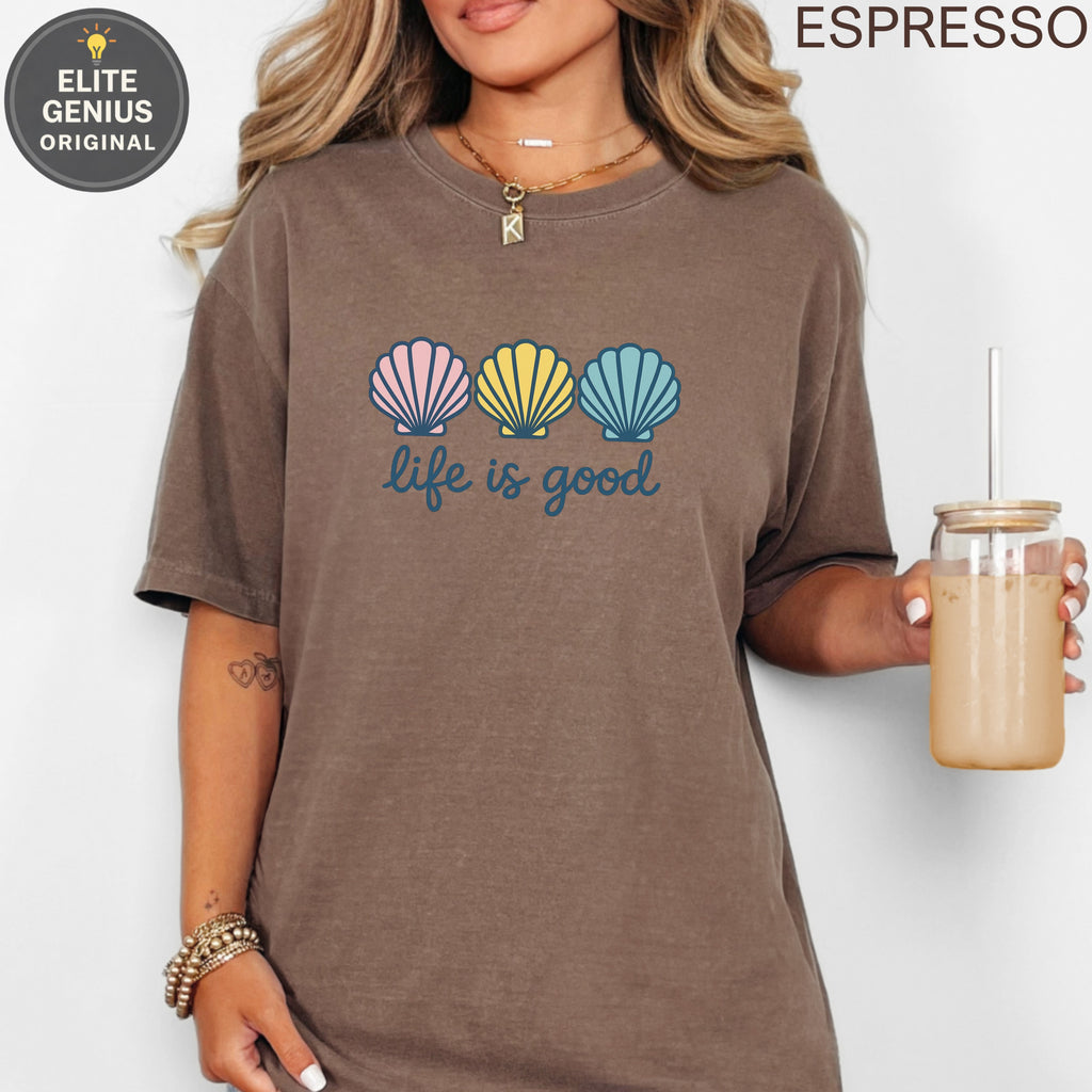 Brown t-shirt with three colorful seashells and "life is good" text.