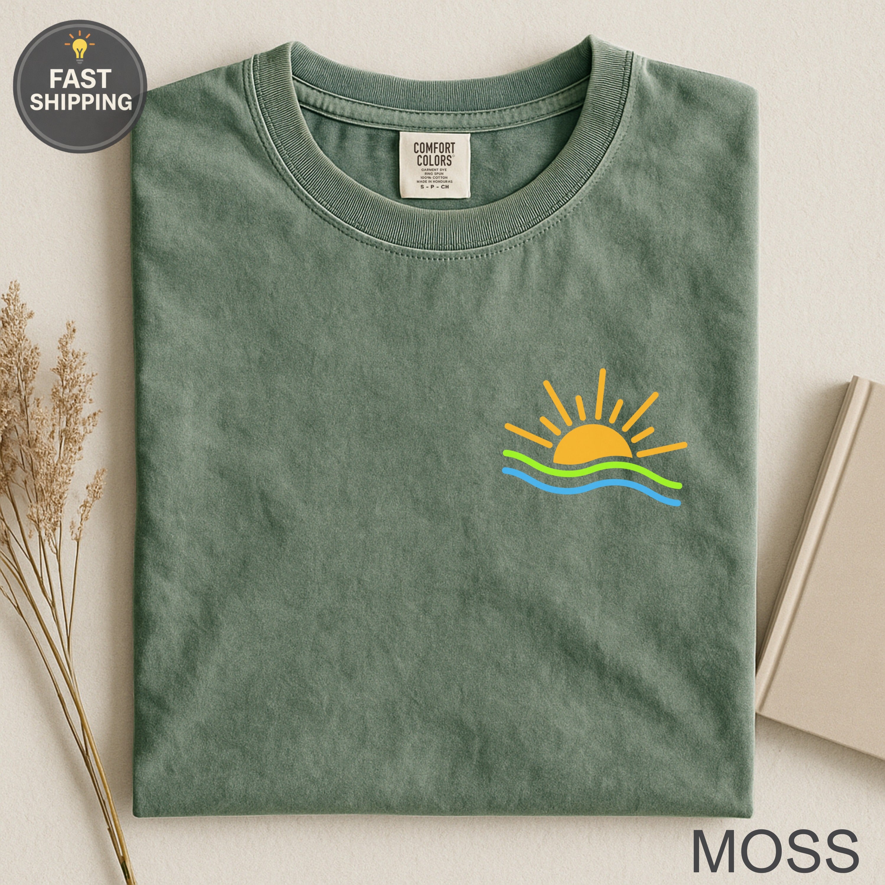 Moss green Comfort Colors t-shirt with sun and wave graphic.