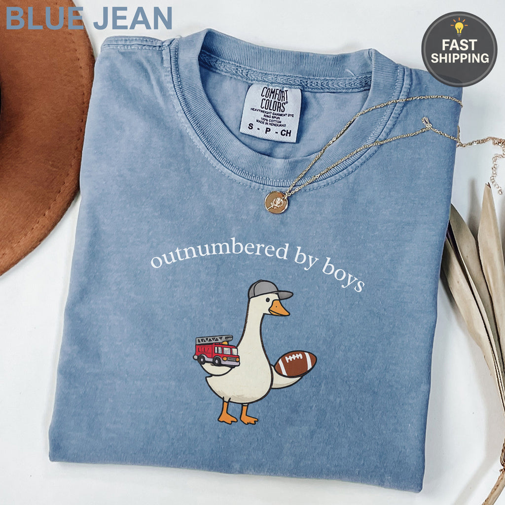 Blue t-shirt with duck, football, and fire truck graphic.