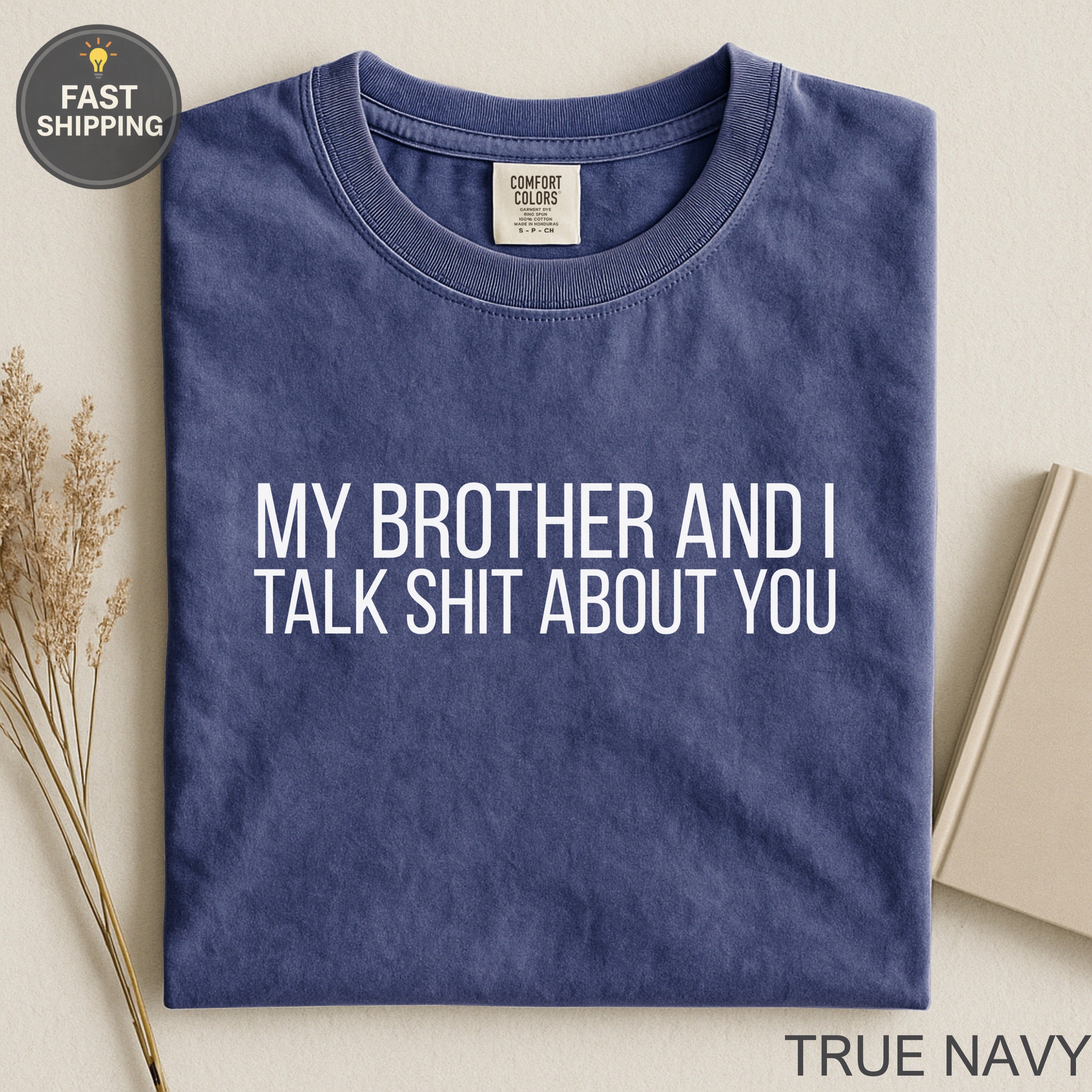 Navy t-shirt with white text "MY BROTHER AND I TALK SHIT ABOUT YOU."