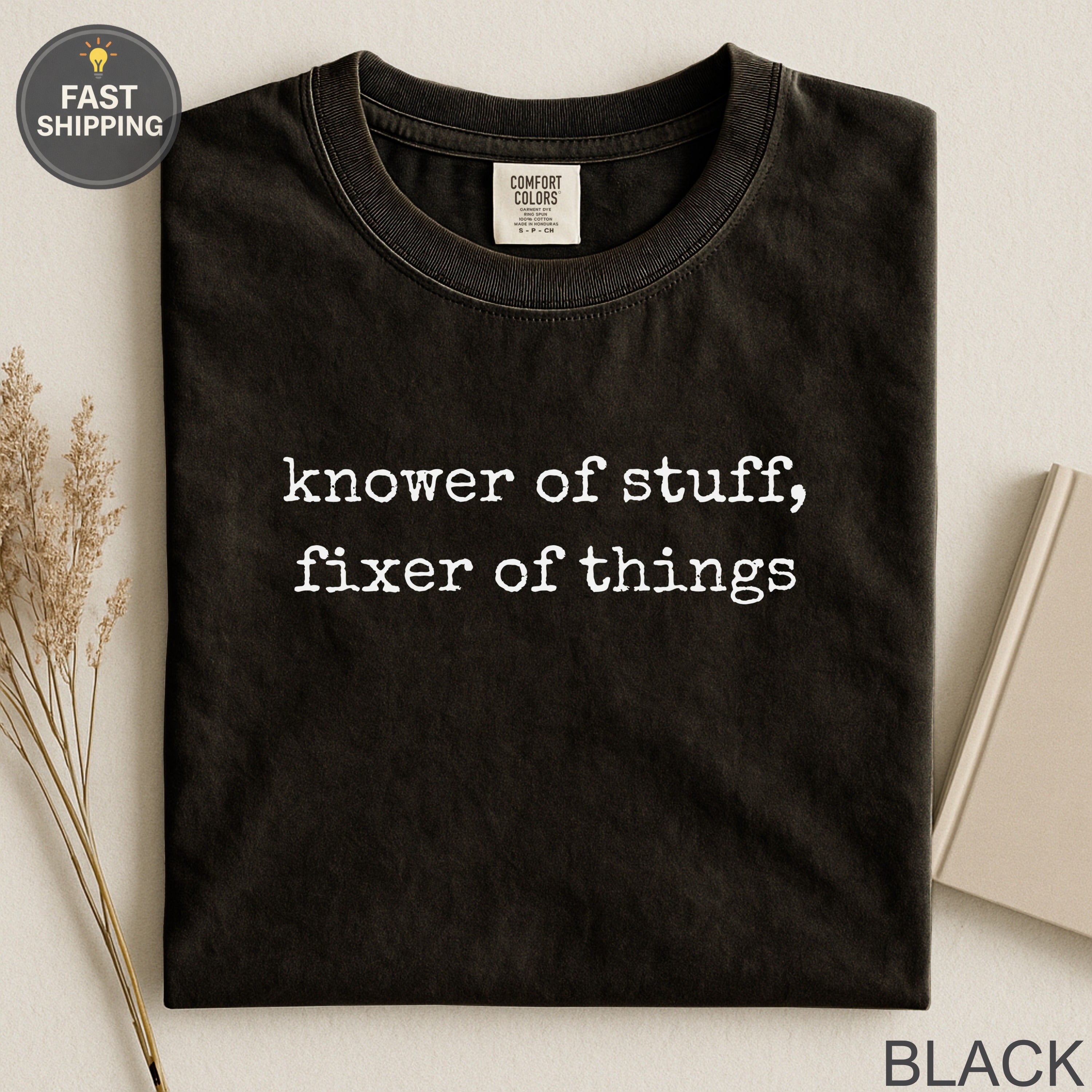 Black Comfort Colors t-shirt with white text "knower of stuff, fixer of things."