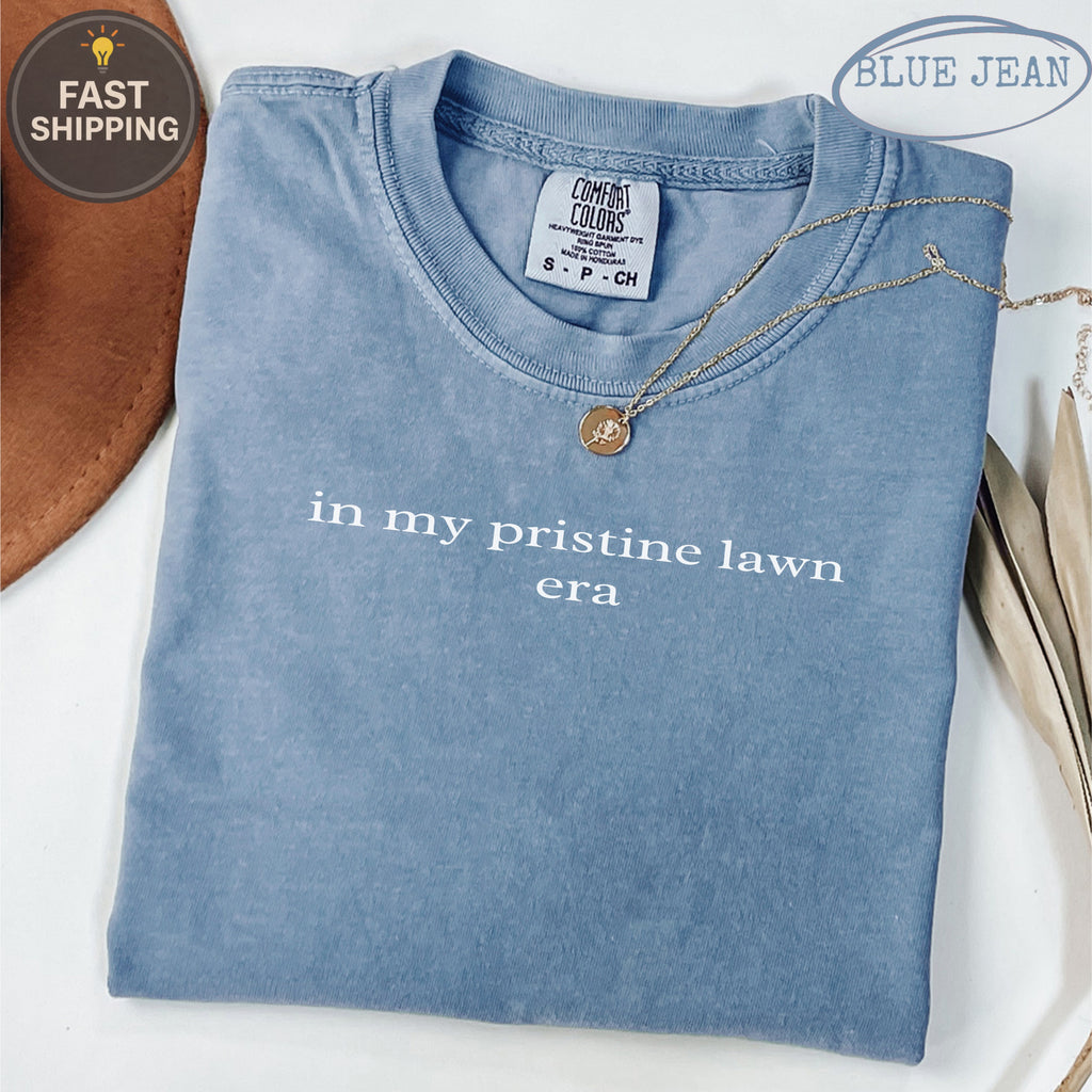 Blue Jean Comfort Colors t-shirt with "in my pristine lawn era" text.