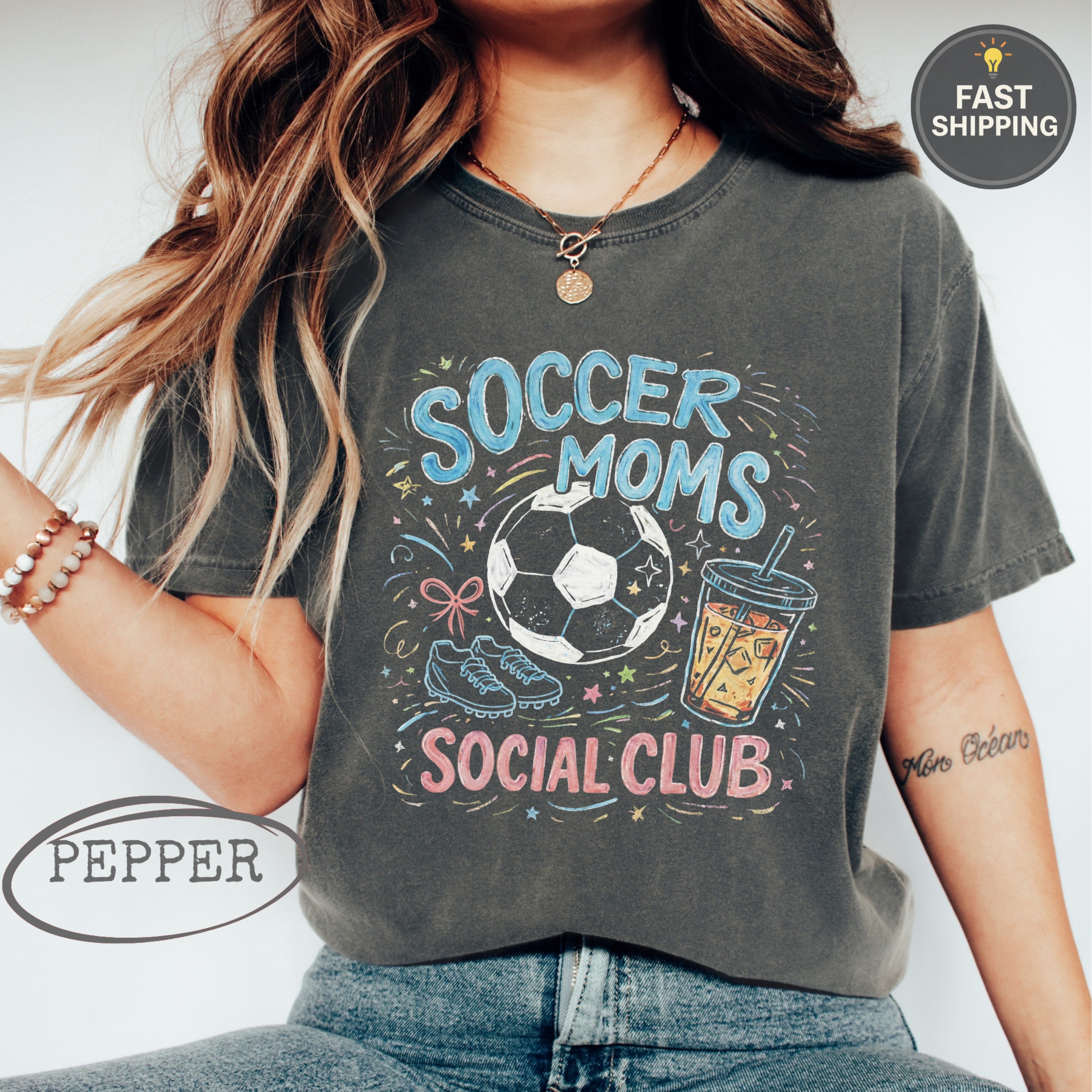 "Soccer Moms Social Club" graphic tee with soccer ball, drink, and sparkles.