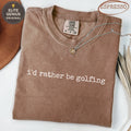 Brown Comfort Colors t-shirt with "i'd rather be golfing" text.