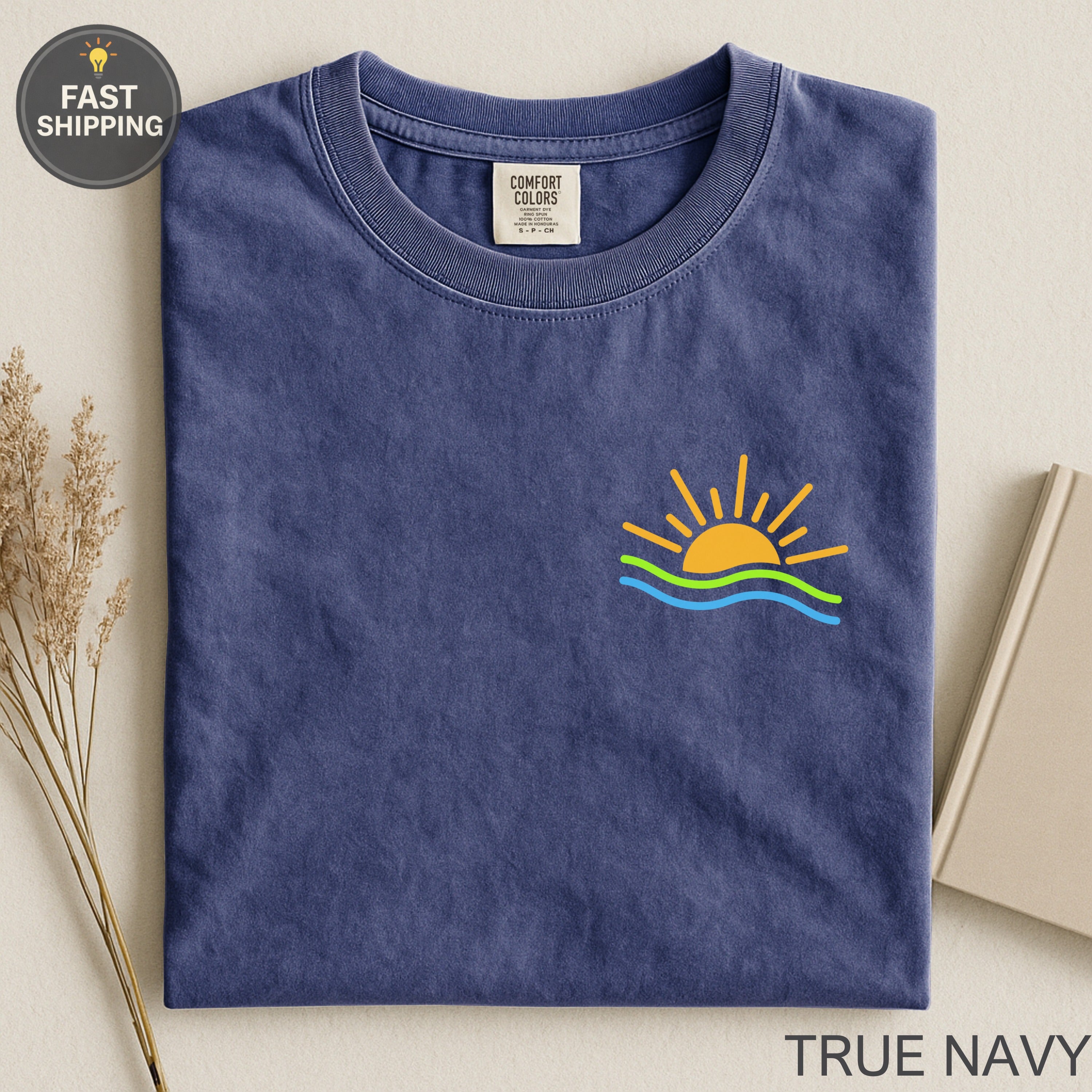 Navy blue t-shirt with sun and waves graphic and "True Navy" text.