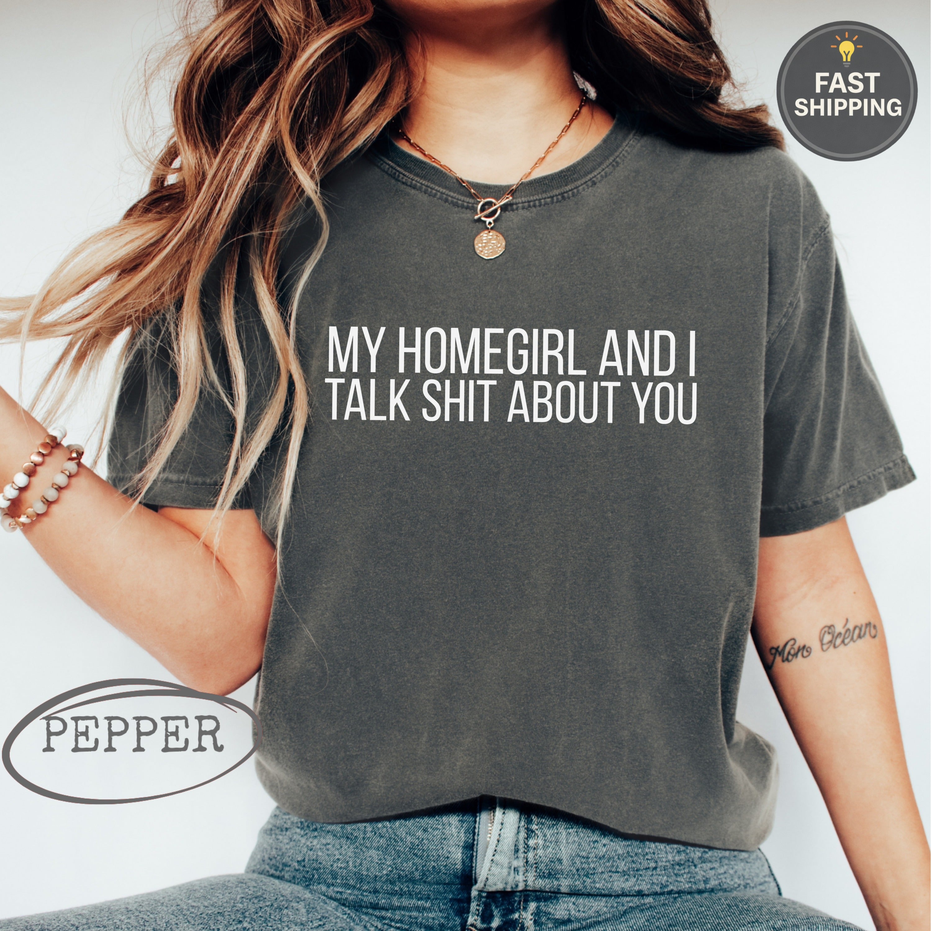 Dark grey t-shirt with white text "MY HOMEGIRL AND I TALK SHIT ABOUT YOU."