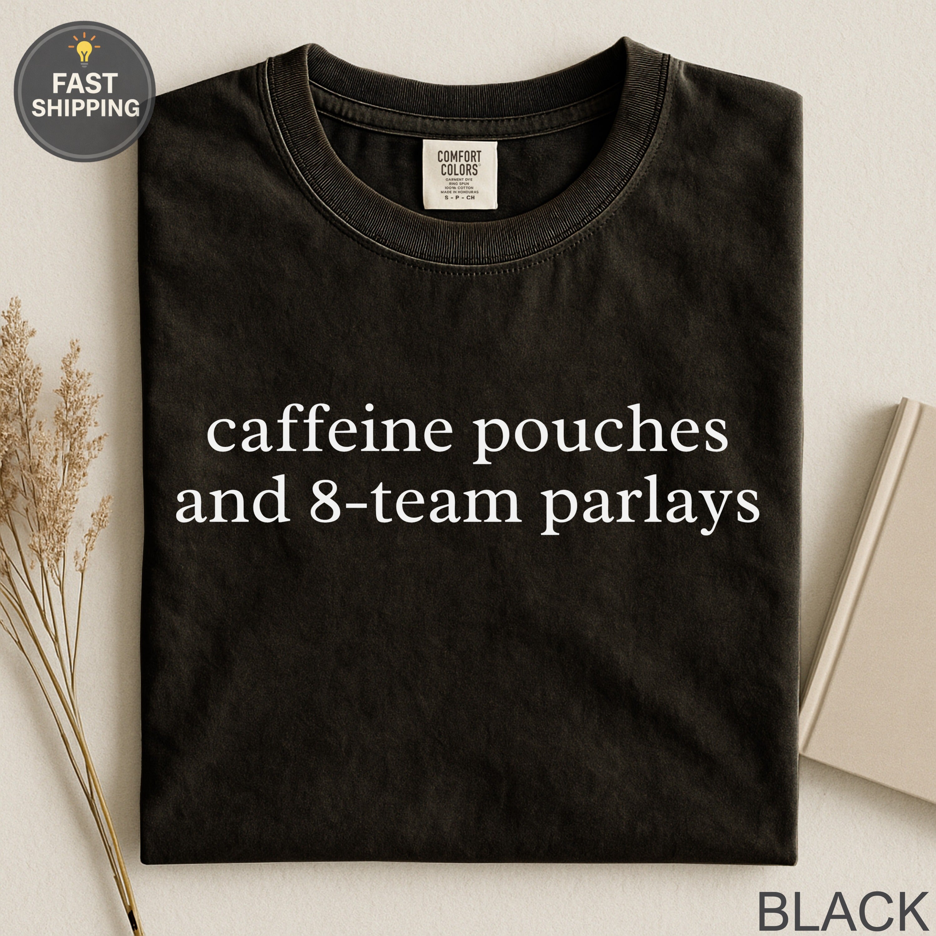 Black t-shirt with "caffeine pouches and 8-team parlays" text.