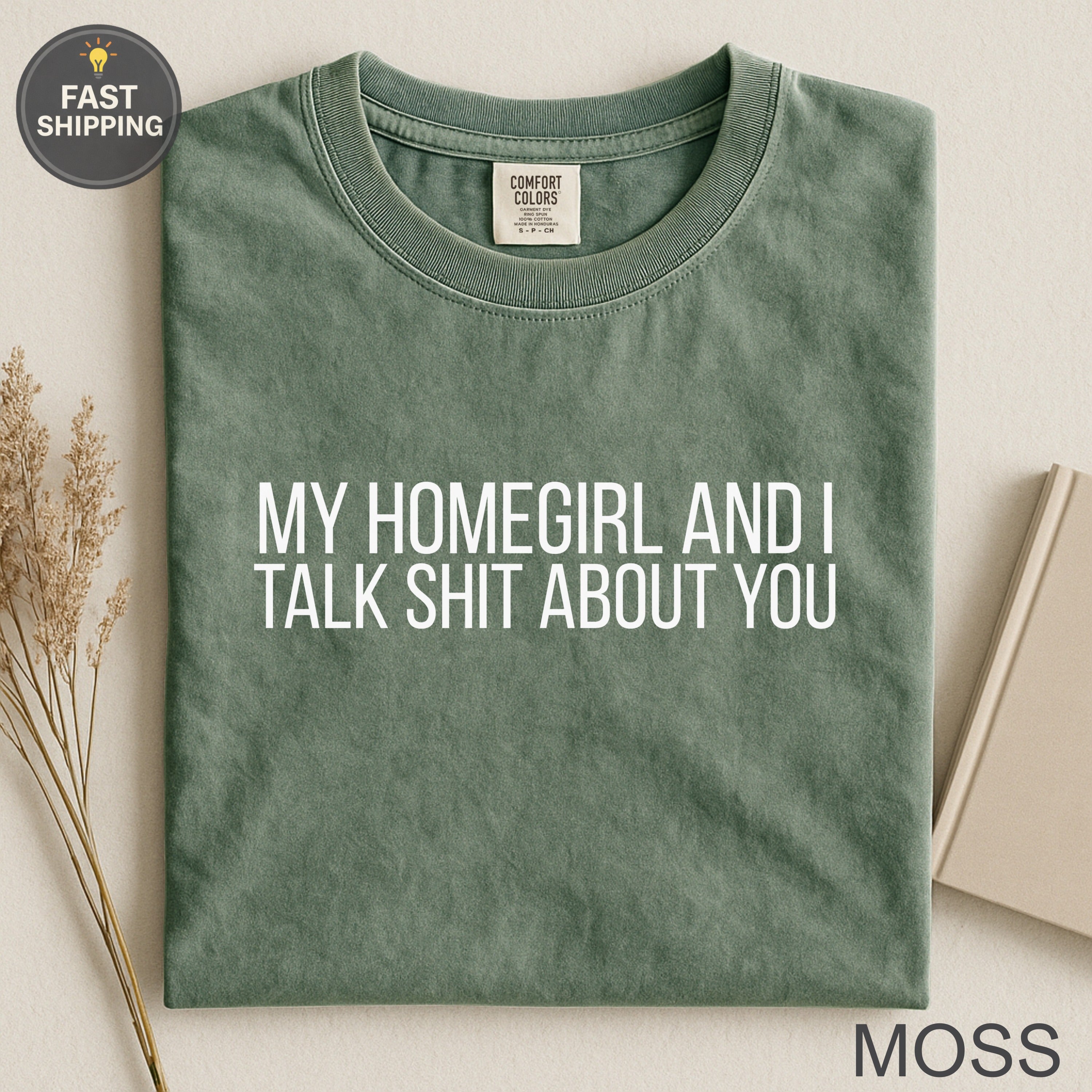 Moss green t-shirt with white text "My homegirl and I talk shit about you."