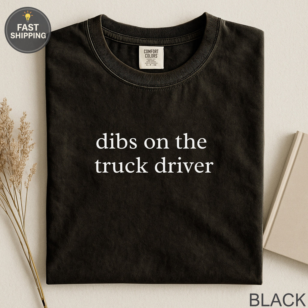Black Comfort Colors t-shirt with "dibs on the truck driver" text.