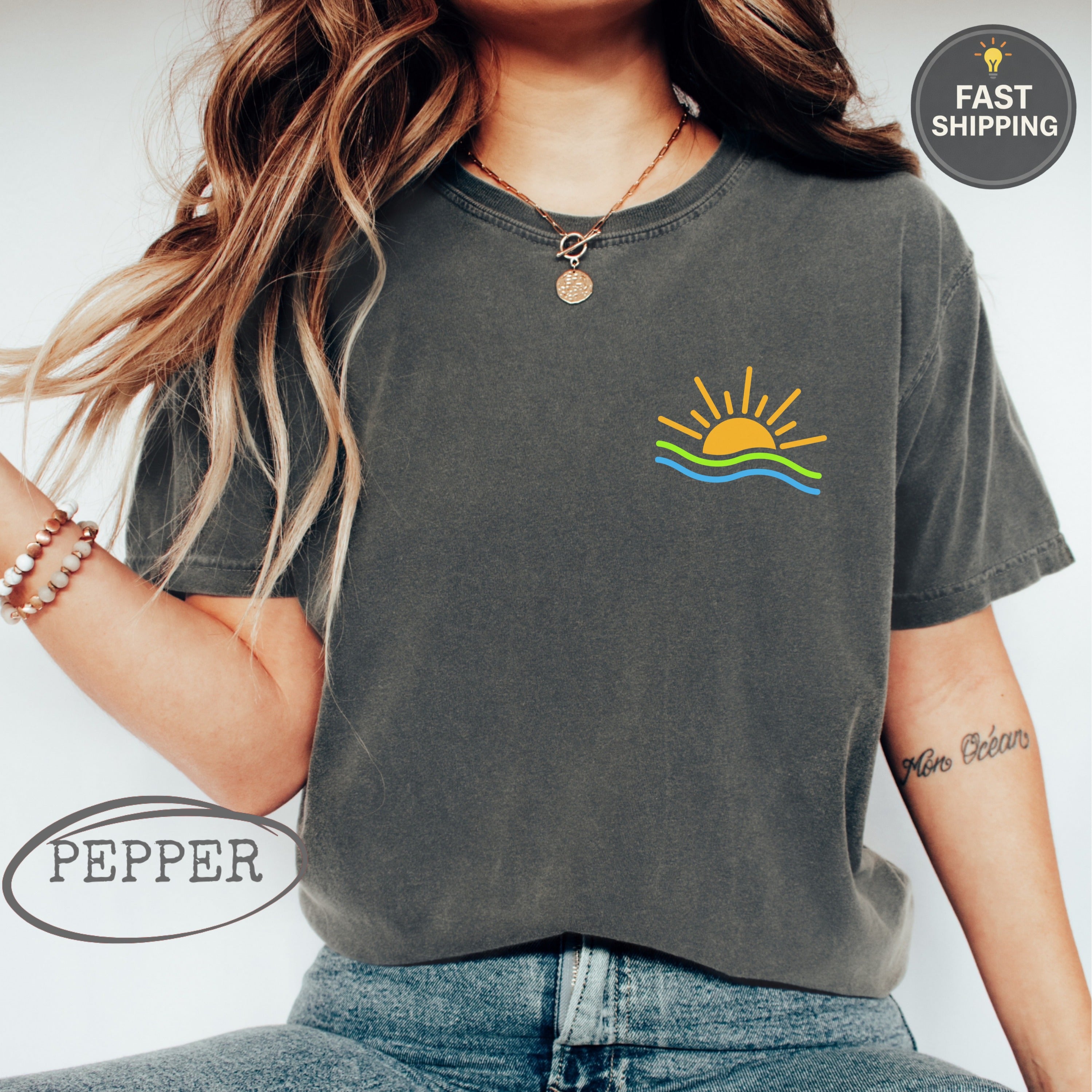 Dark t-shirt with sun and wavy ocean graphic on the chest.