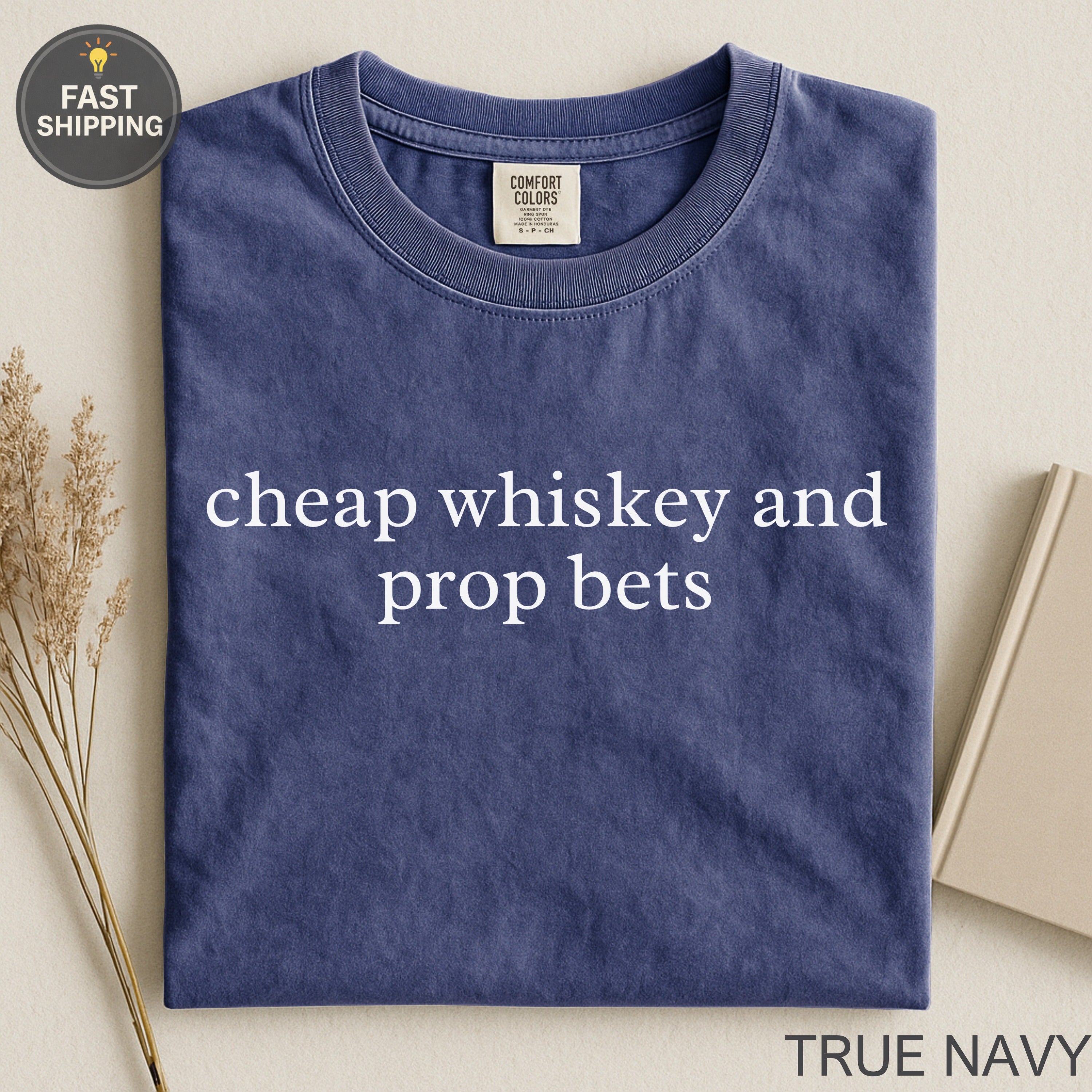 Navy t-shirt with "cheap whiskey and prop bets" text.