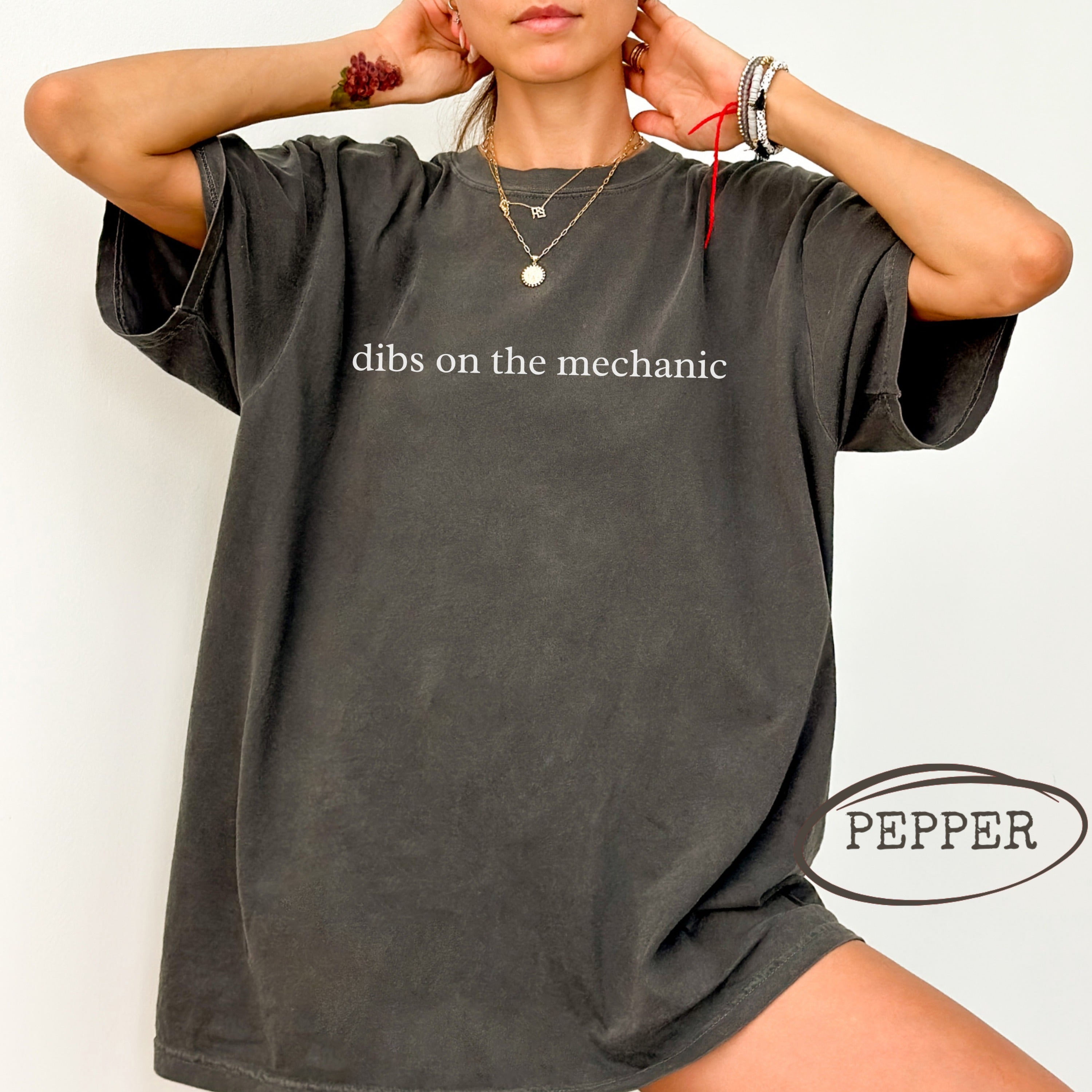 Charcoal graphic tee with "dibs on the mechanic" text and pepper logo.