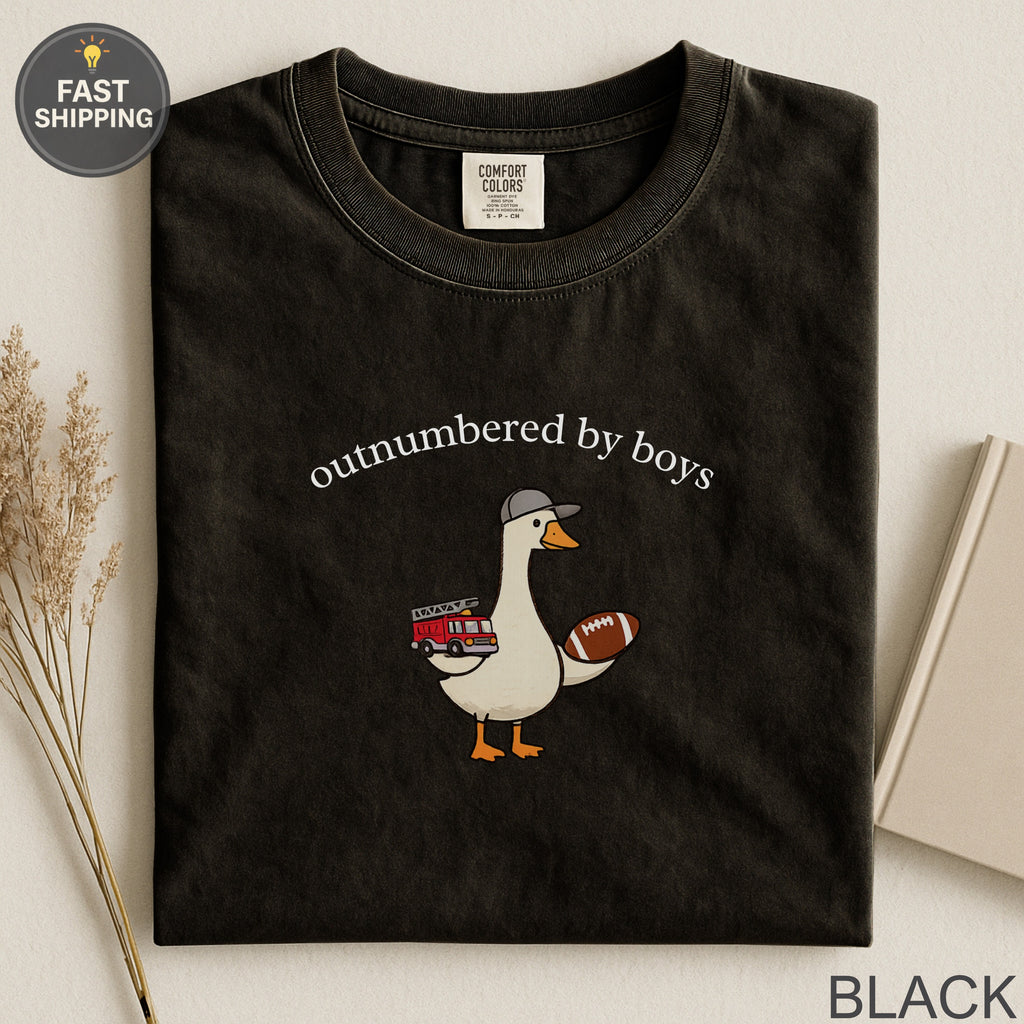 Black t-shirt with "outnumbered by boys" text and a duck holding a football.