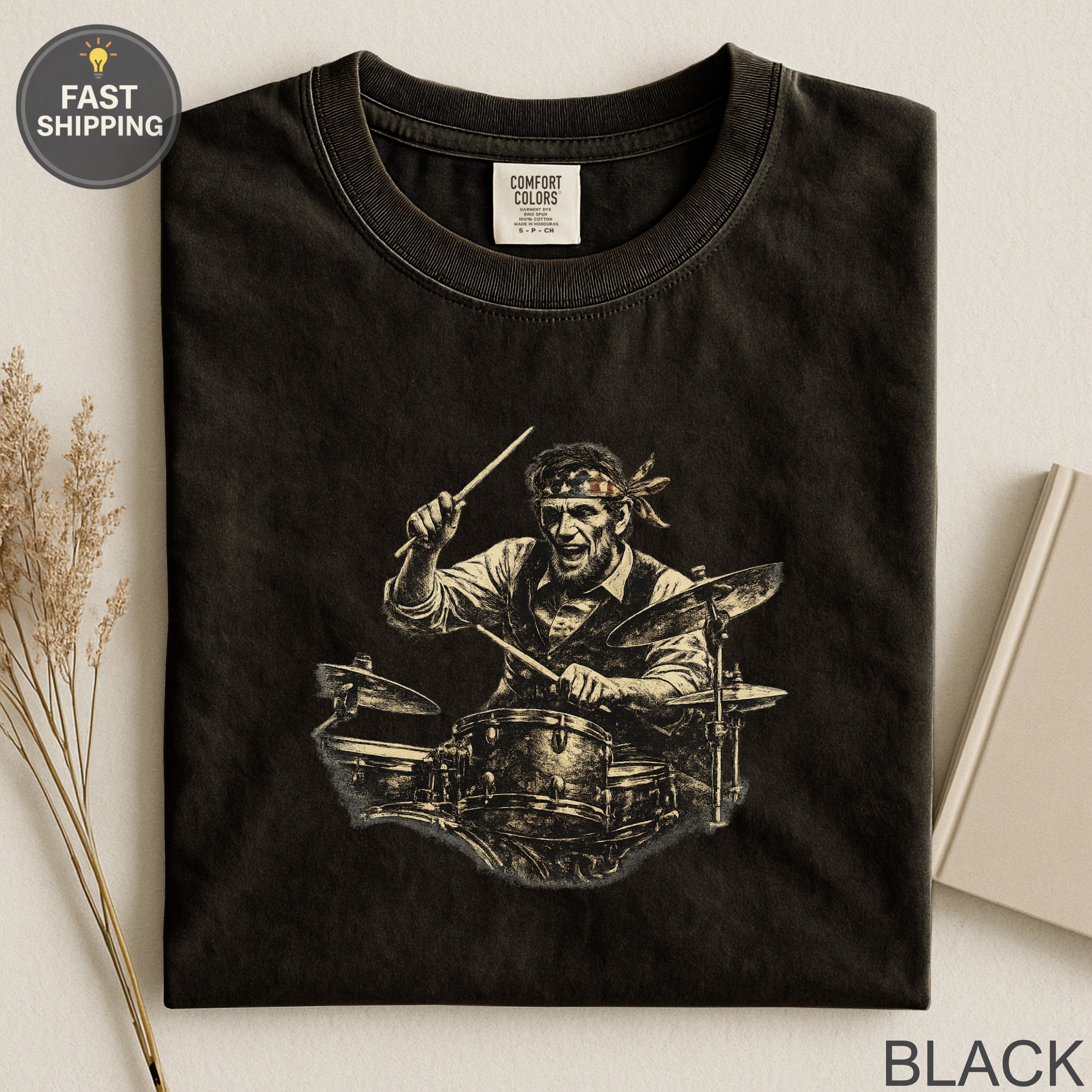 Black t-shirt with graphic of a man playing drums and "FAST SHIPPING" text.