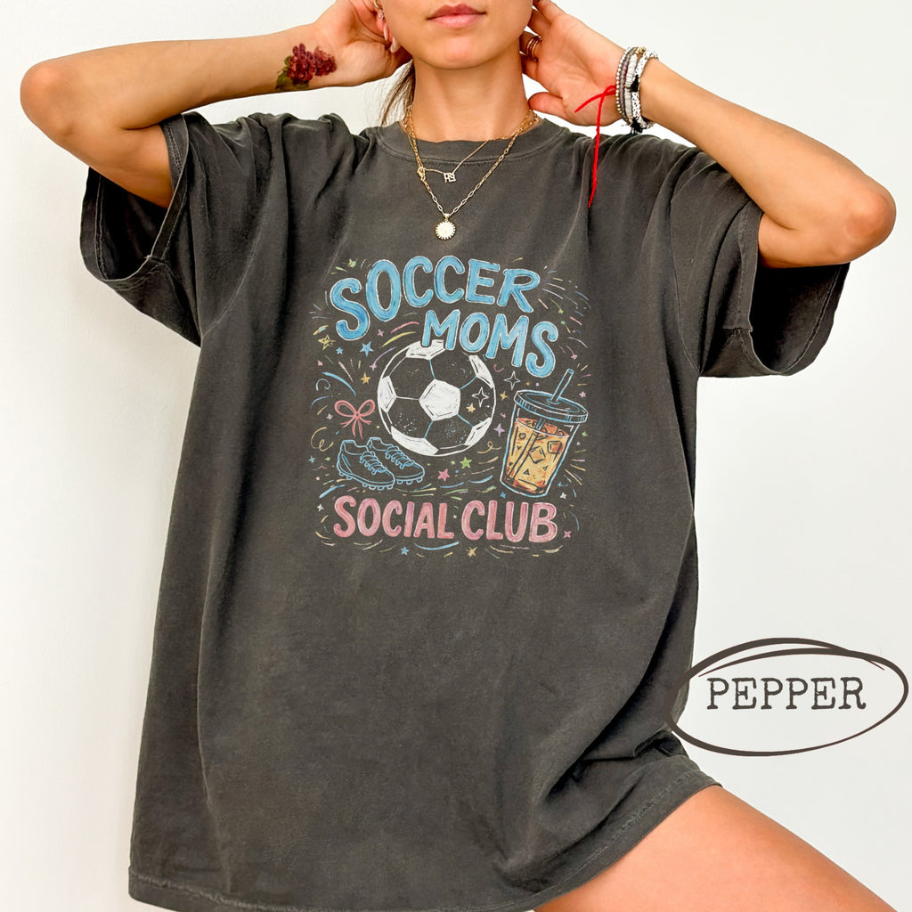 Dark t-shirt with soccer ball, drink, and "Soccer Moms Social Club" text.