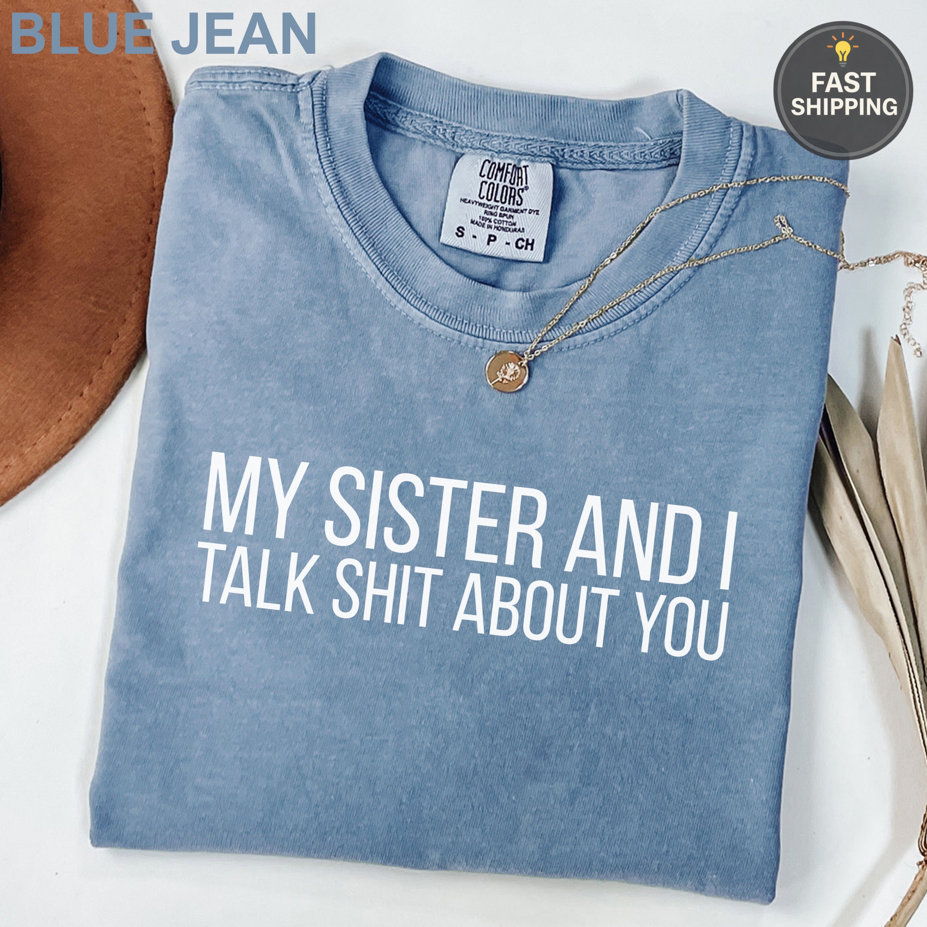 Blue t-shirt with "MY SISTER AND I TALK SHIT ABOUT YOU" text.