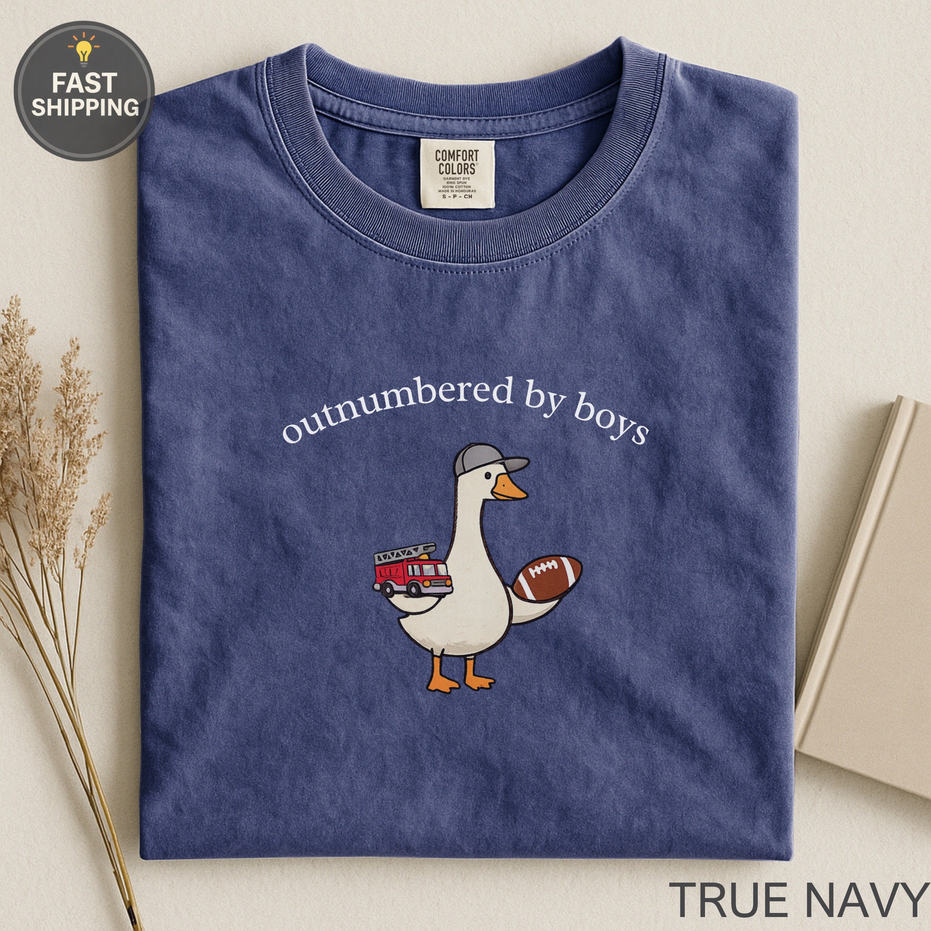 Navy blue t-shirt with "outnumbered by boys" and a goose holding a football and fire truck.