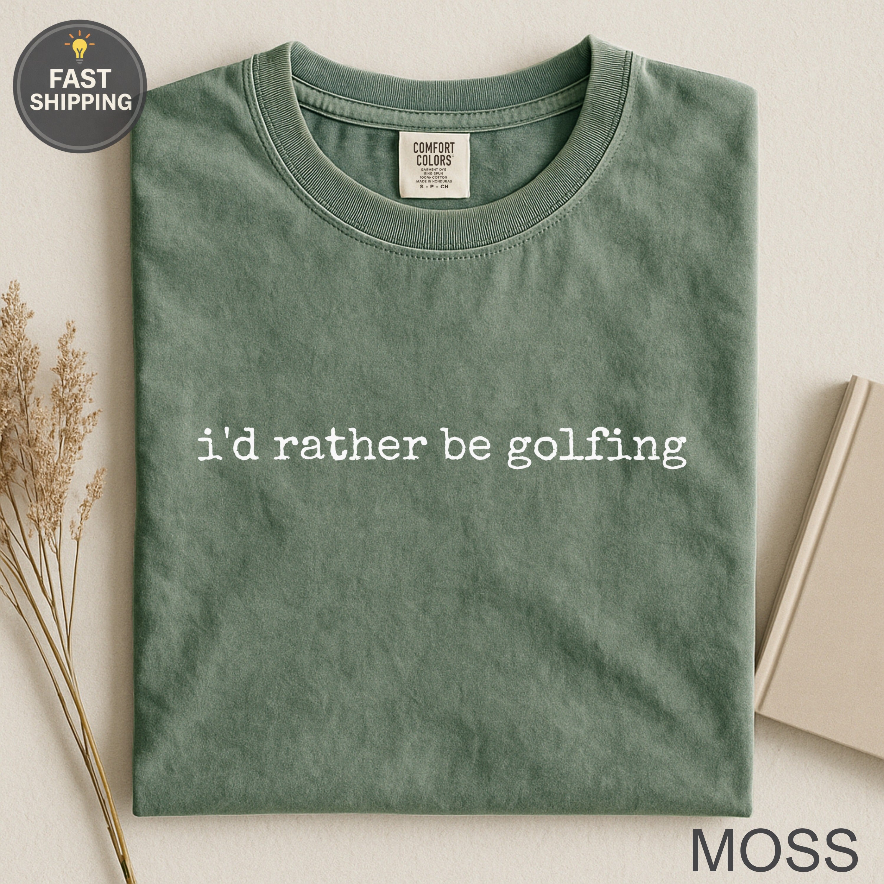 Comfort Colors moss green t-shirt with "i'd rather be golfing" text.