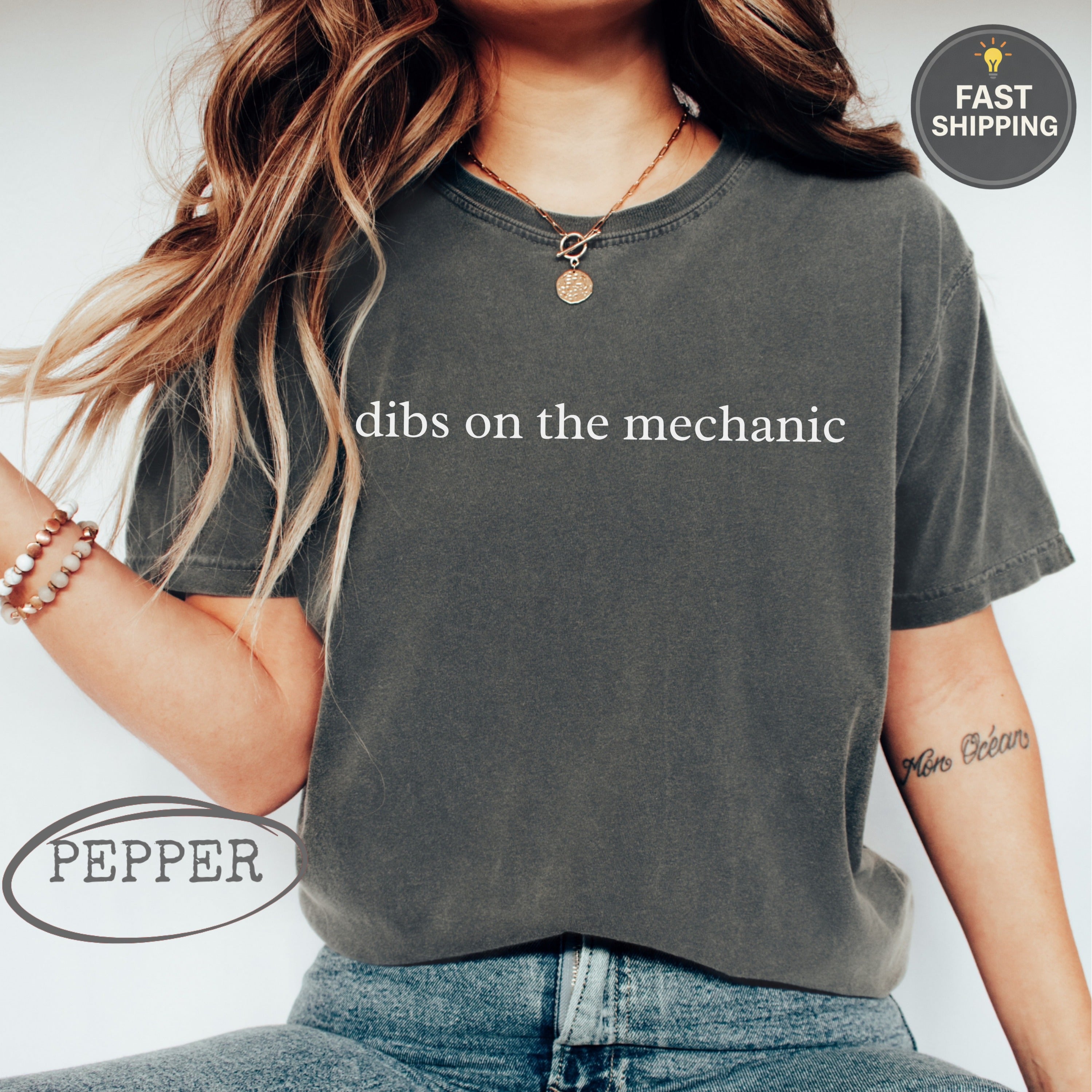Dark grey t-shirt with "dibs on the mechanic" text and "Pepper" logo.