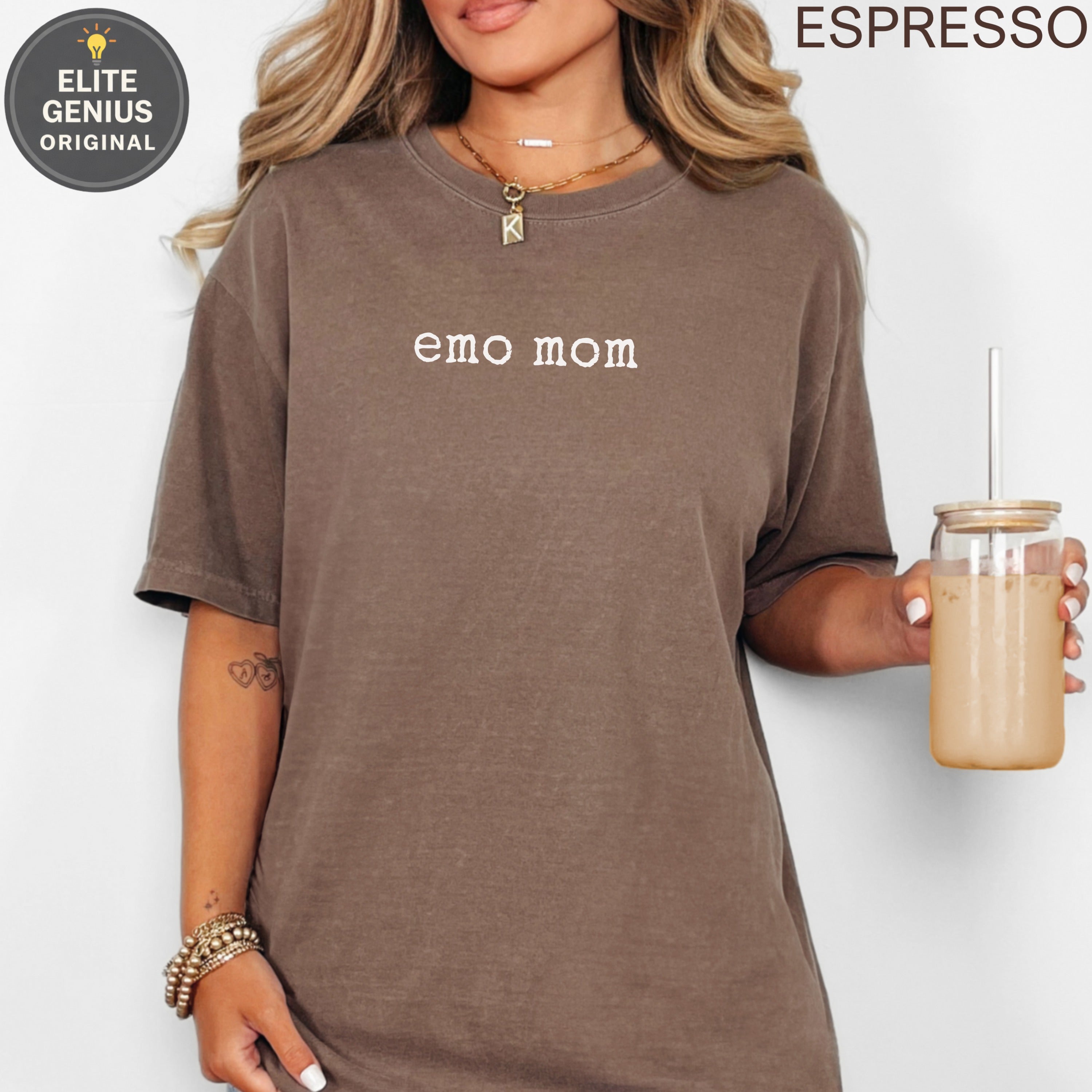 Brown t-shirt with "emo mom" text, held by a person with a drink.