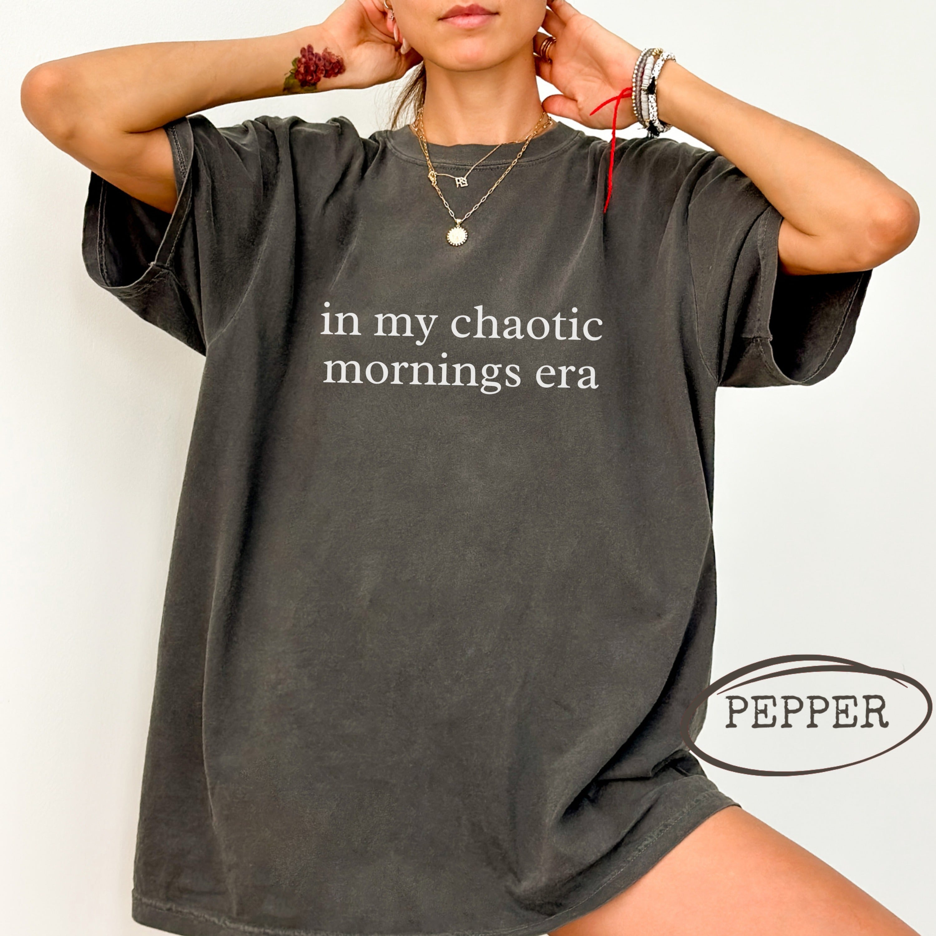 Dark grey t-shirt with "in my chaotic mornings era" text and "Pepper" logo.