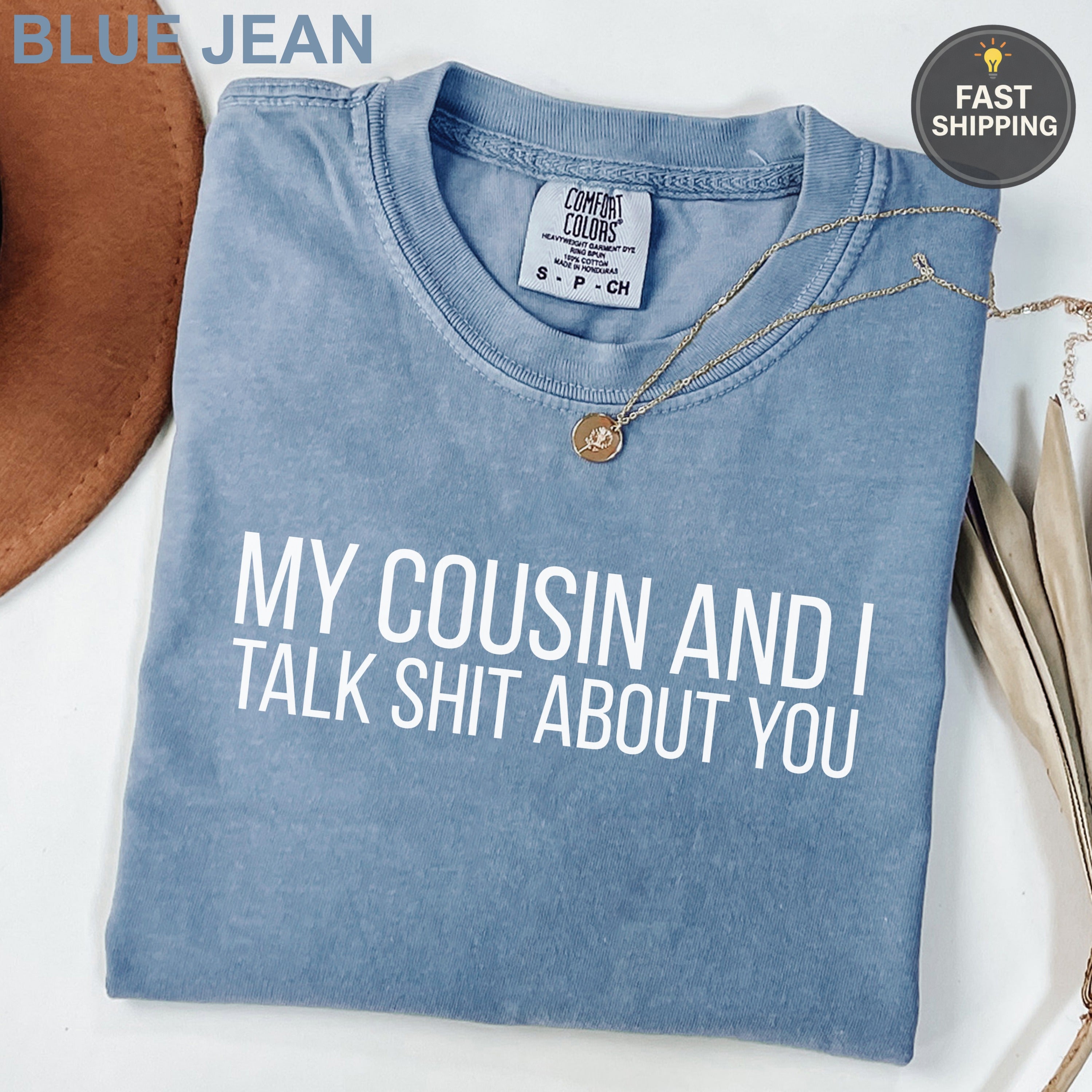 Blue Jean Comfort Colors t-shirt with "MY COUSIN AND I TALK SHIT ABOUT YOU" text.