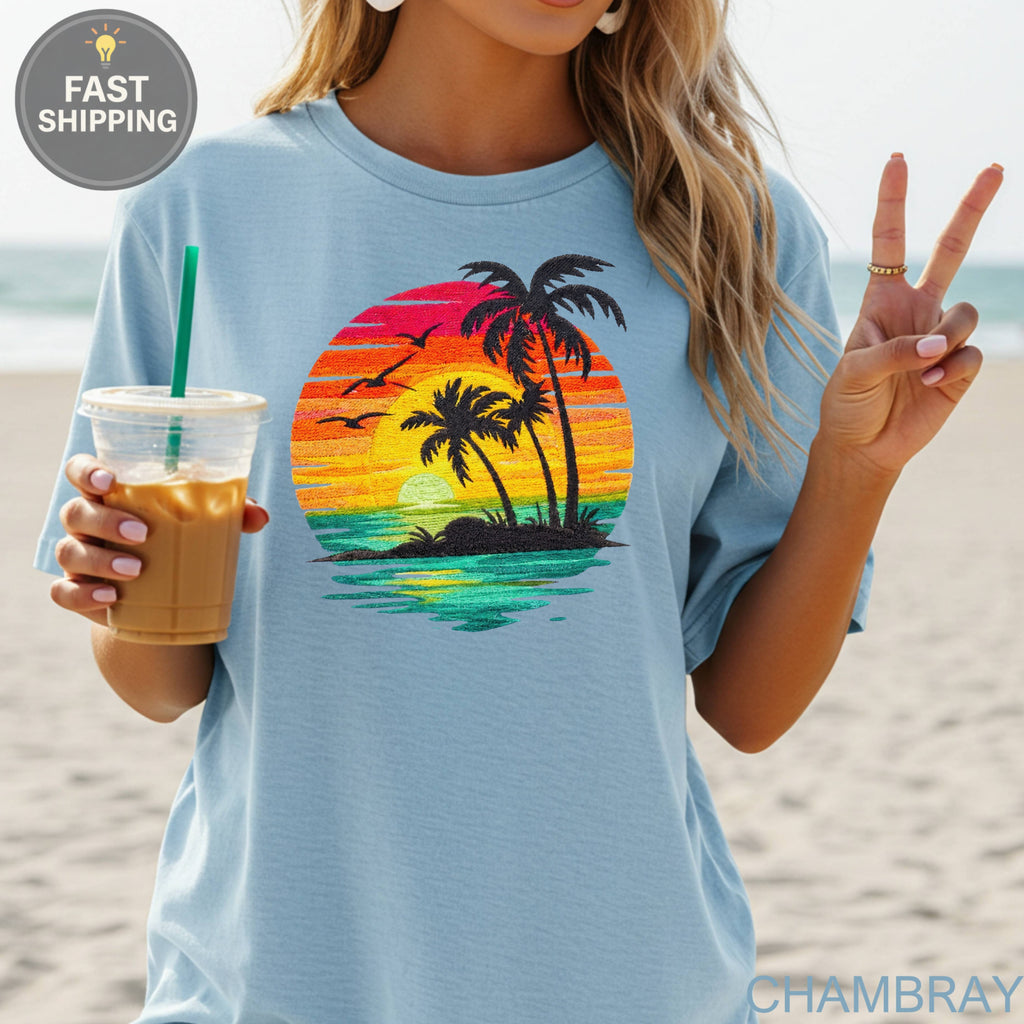 T-shirt with sunset, palm trees, and ocean graphic.