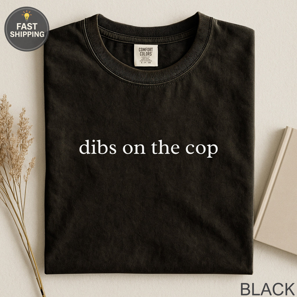 Black Comfort Colors t-shirt with "dibs on the cop" printed in white.