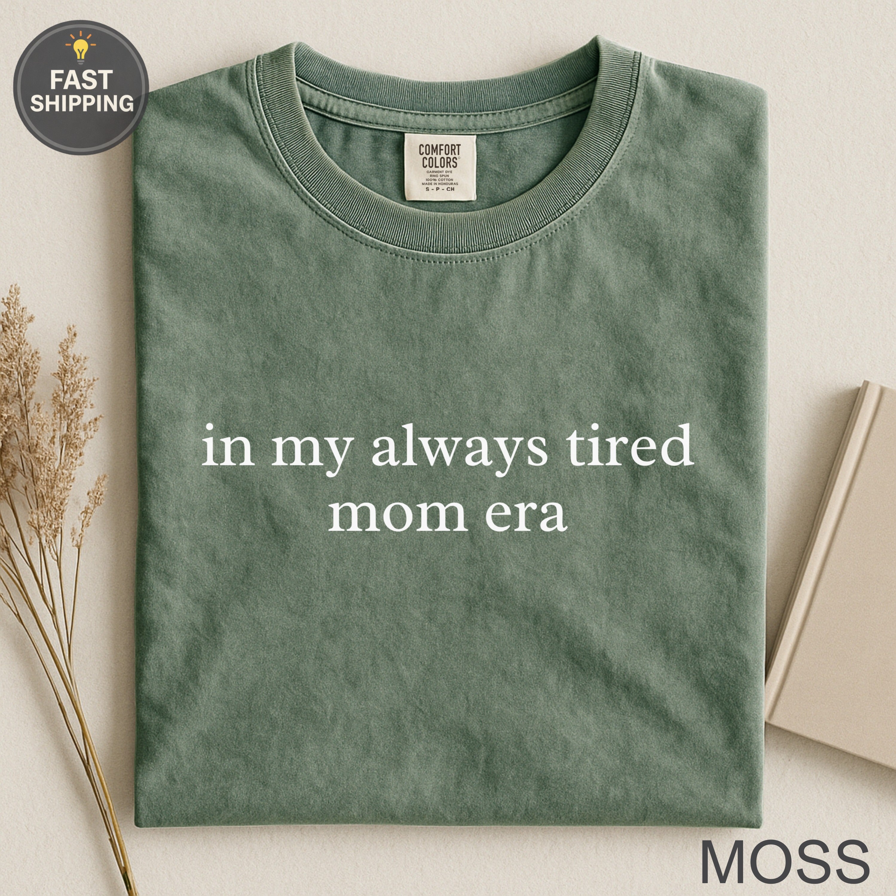 Green t-shirt with "in my always tired mom era" text.