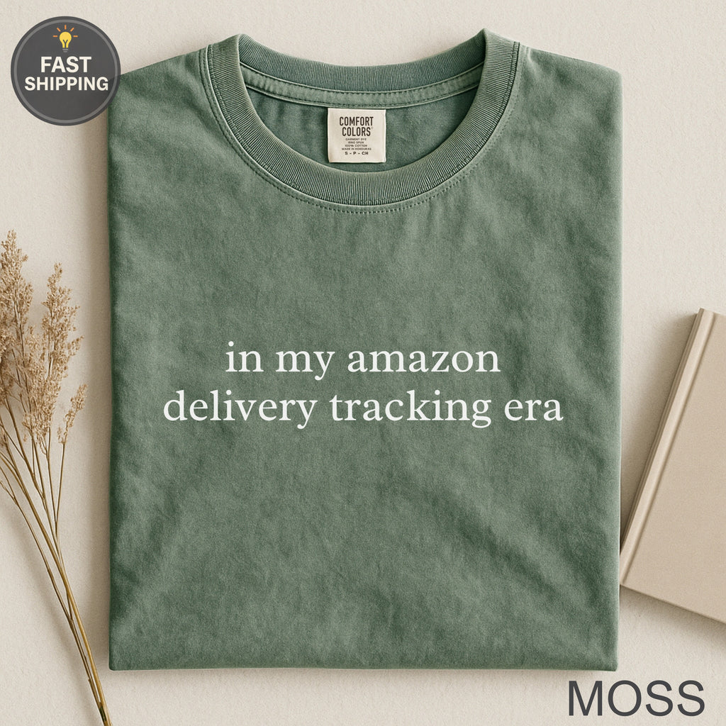 Green t-shirt with "in my amazon delivery tracking era" text.