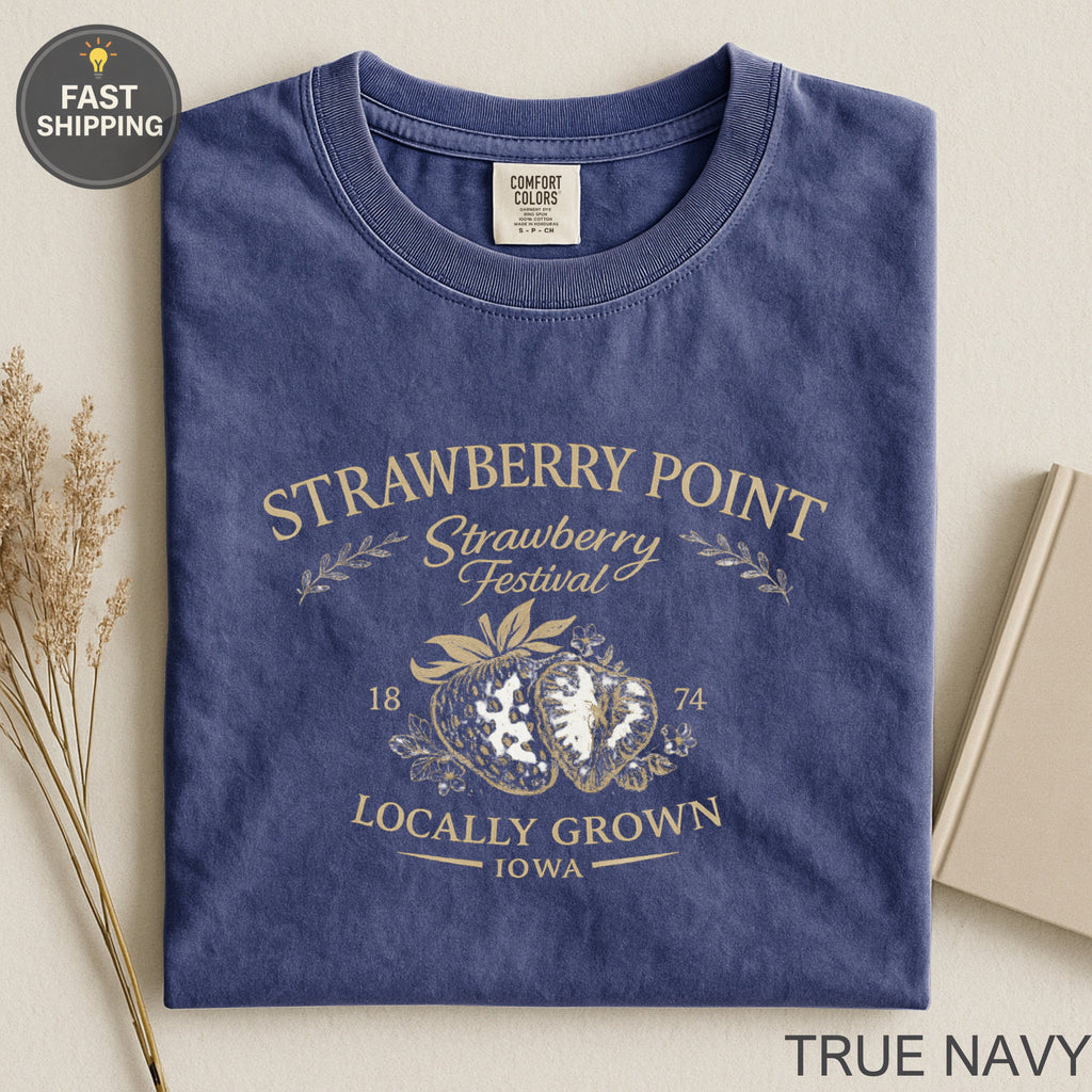 Navy t-shirt with "Strawberry Point Strawberry Festival" graphic and distressed strawberries.