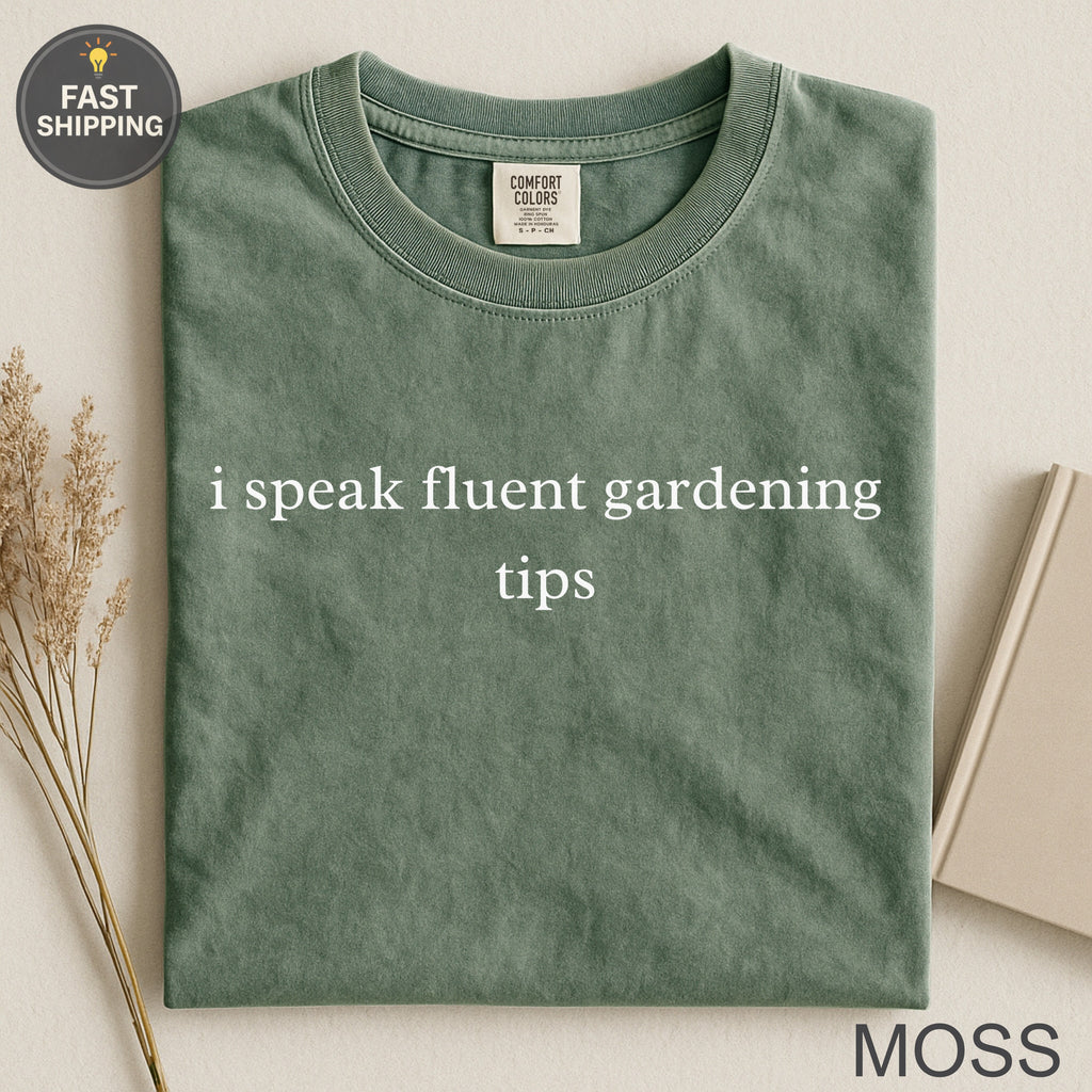 Green t-shirt with "i speak fluent gardening tips" text and "MOSS" label.