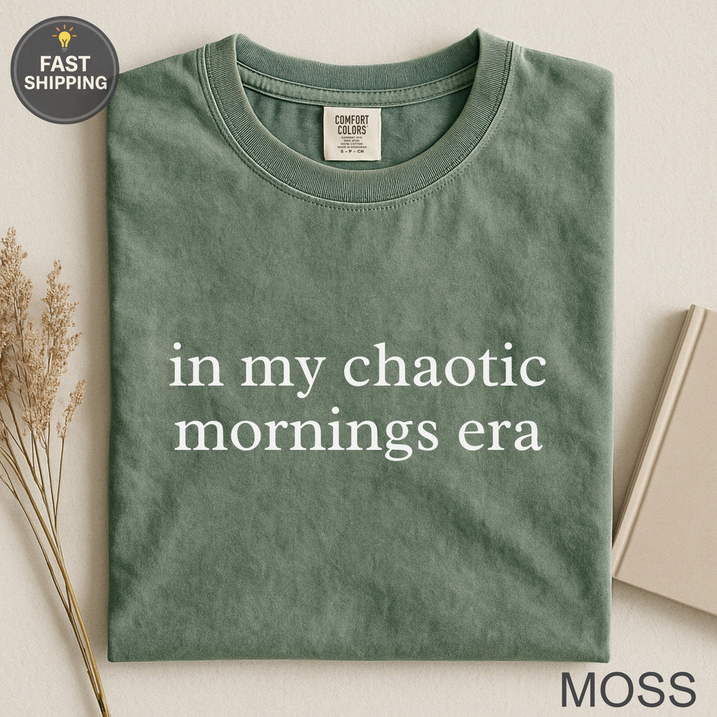 Moss green t-shirt with "in my chaotic mornings era" text.