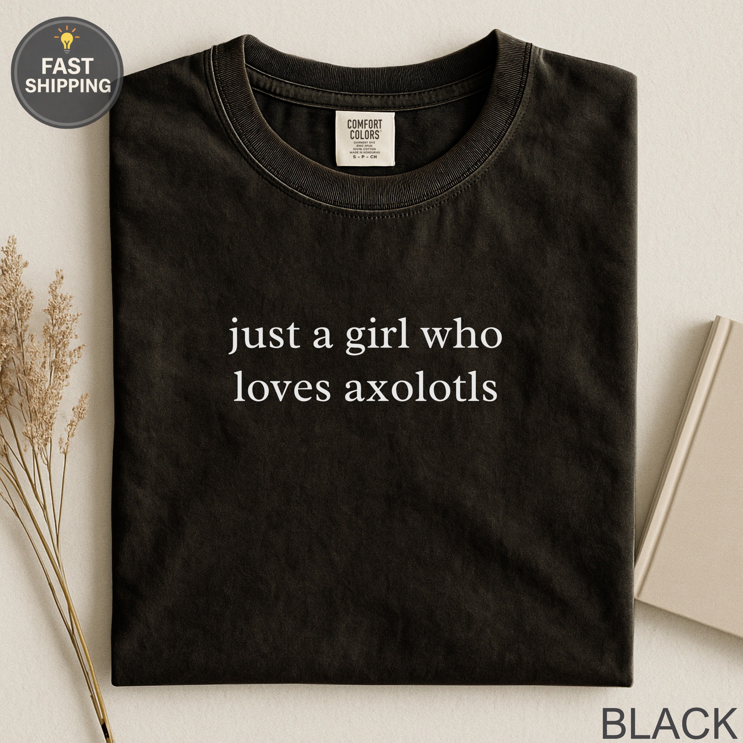 Black t-shirt with "just a girl who loves axolotls" printed in white.