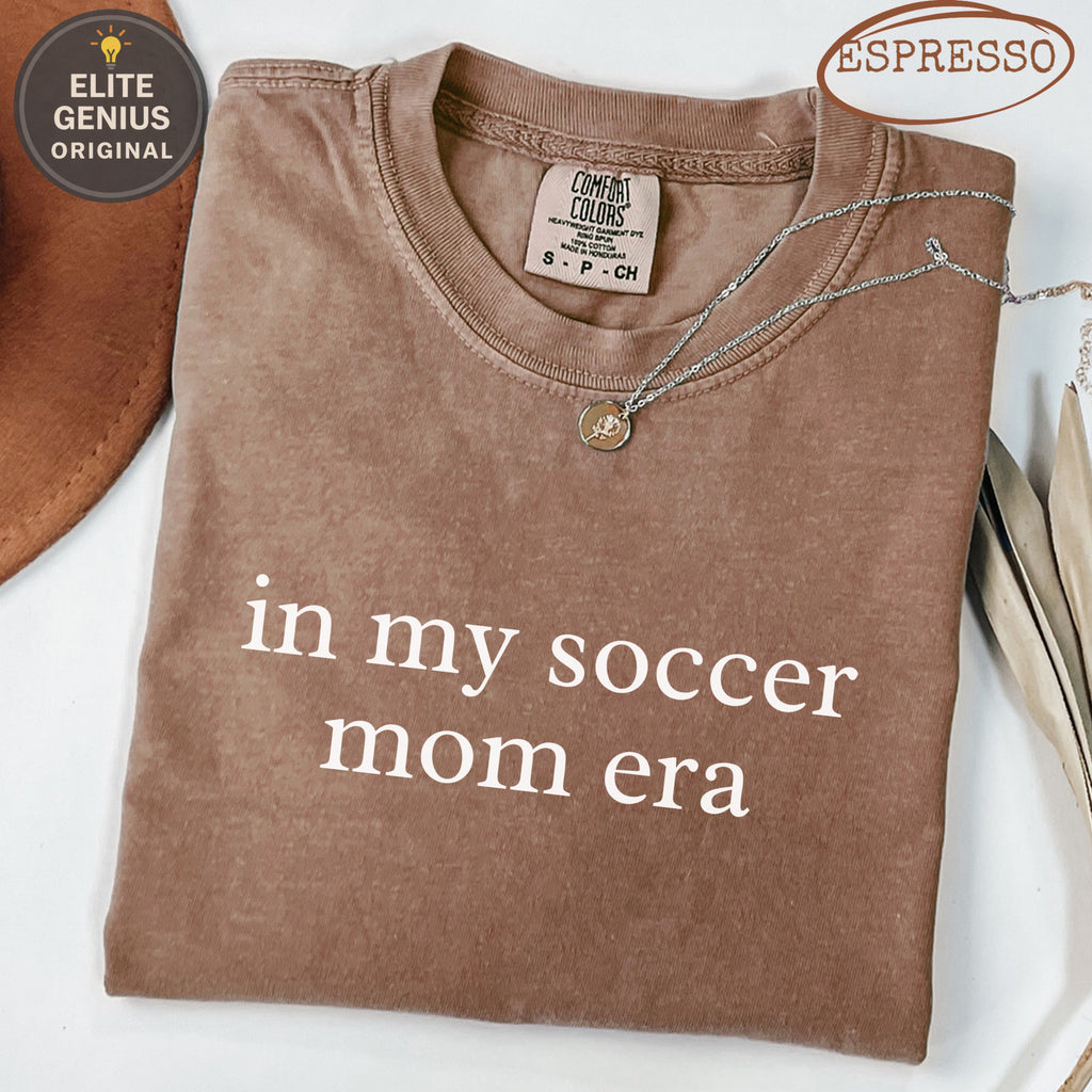 Brown t-shirt with "in my soccer mom era" text.