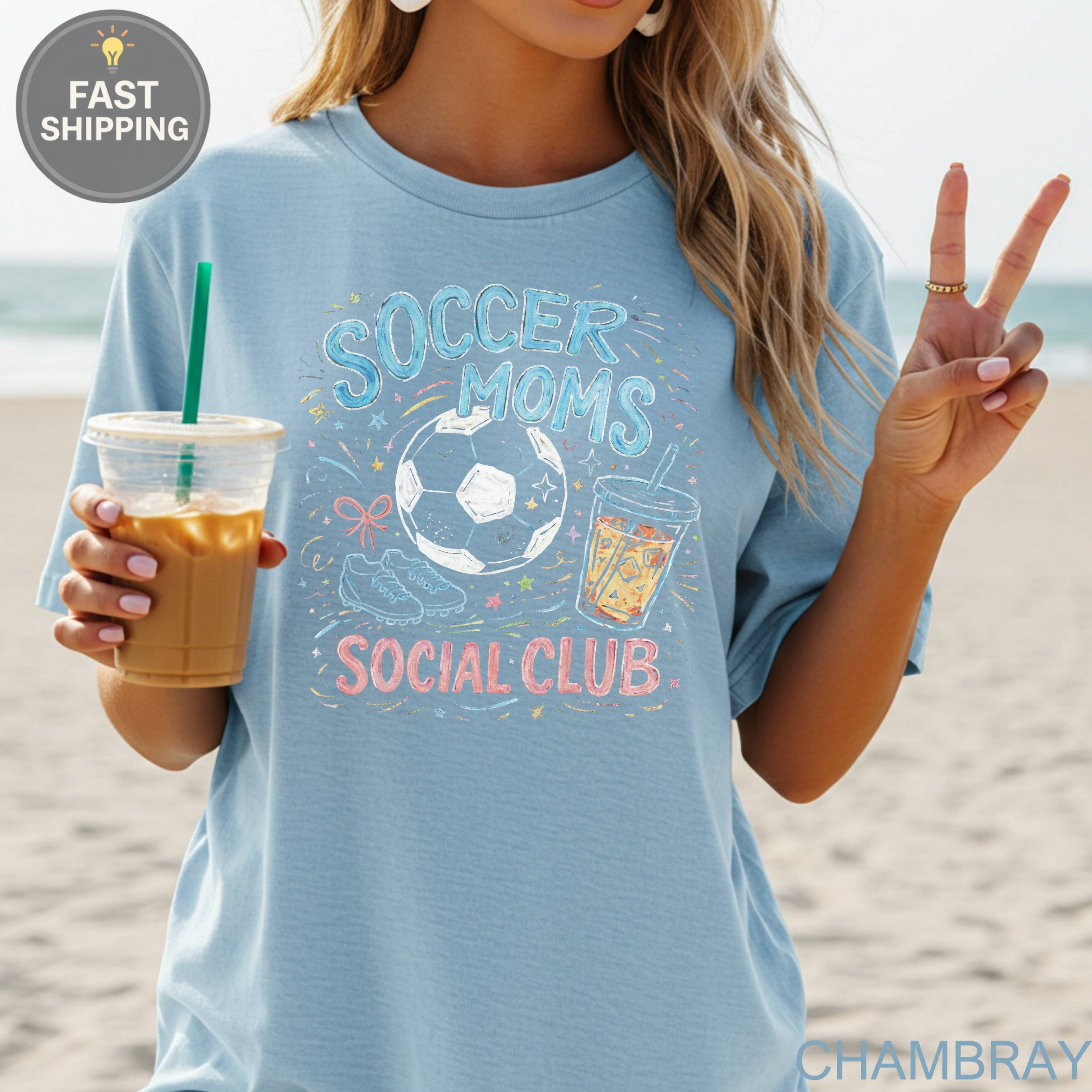 Blue t-shirt with "Soccer Moms Social Club" graphic featuring a soccer ball and drinks.