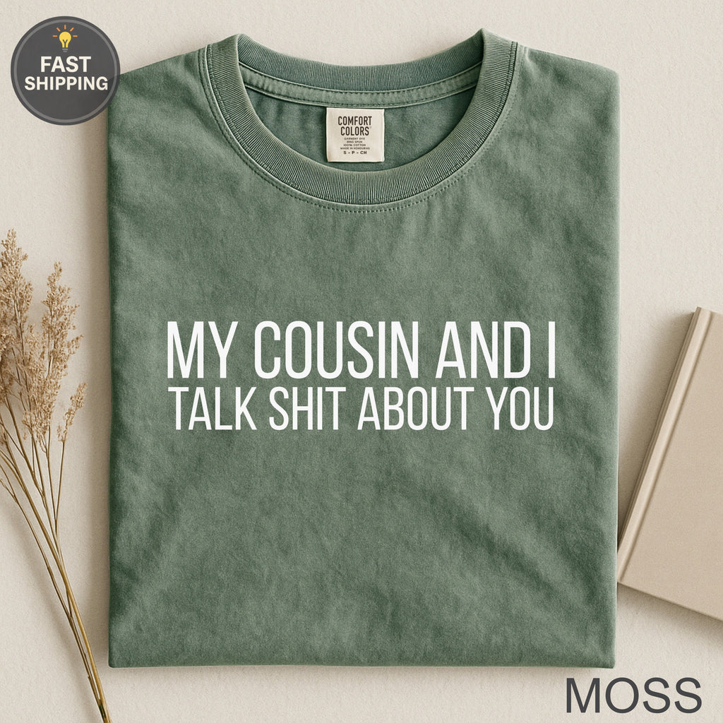 Green t-shirt with white text: "MY COUSIN AND I TALK SHIT ABOUT YOU."