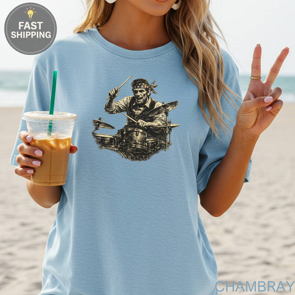 Light blue t-shirt with black graphic of a drummer playing drums.