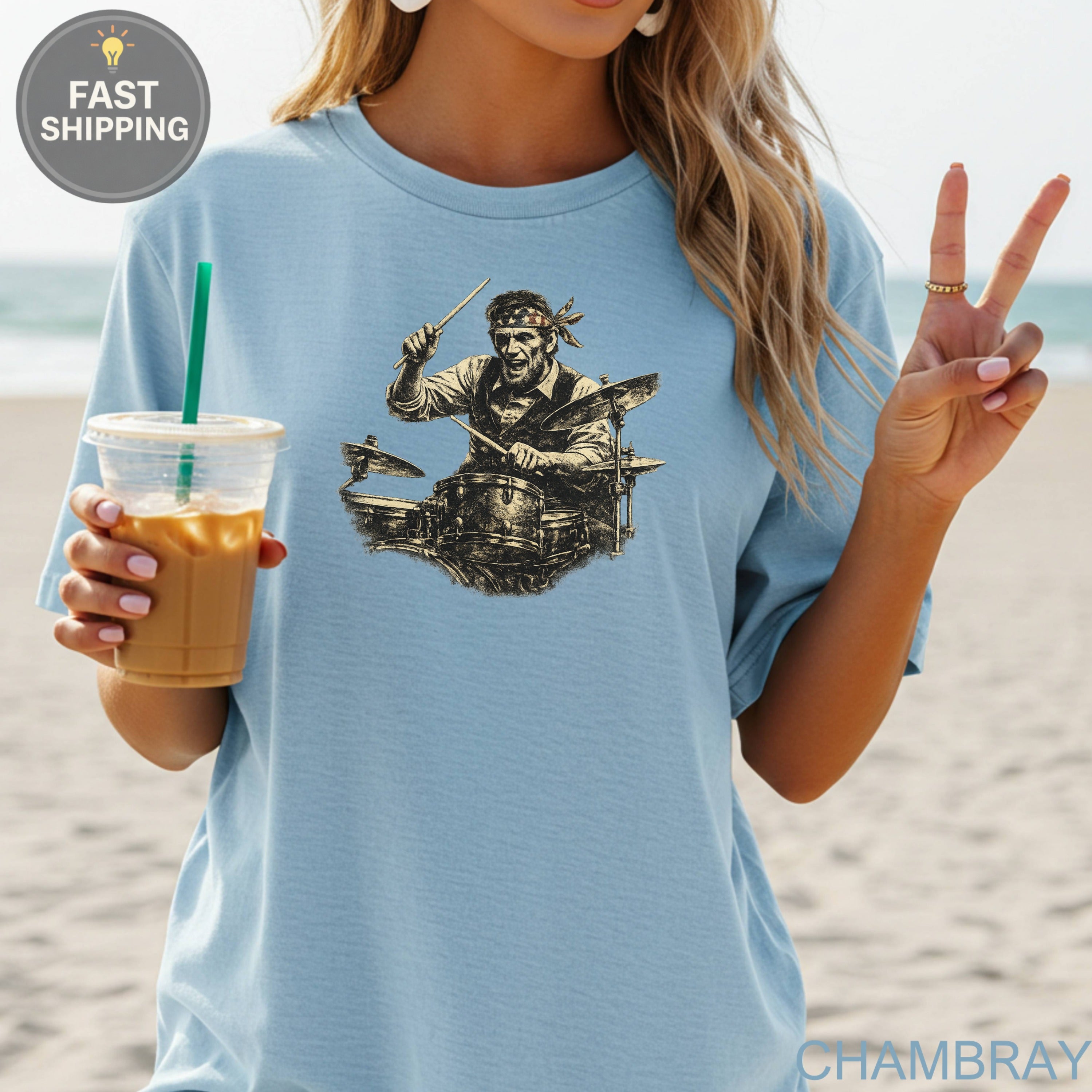 Light blue t-shirt with black graphic of a drummer playing drums.