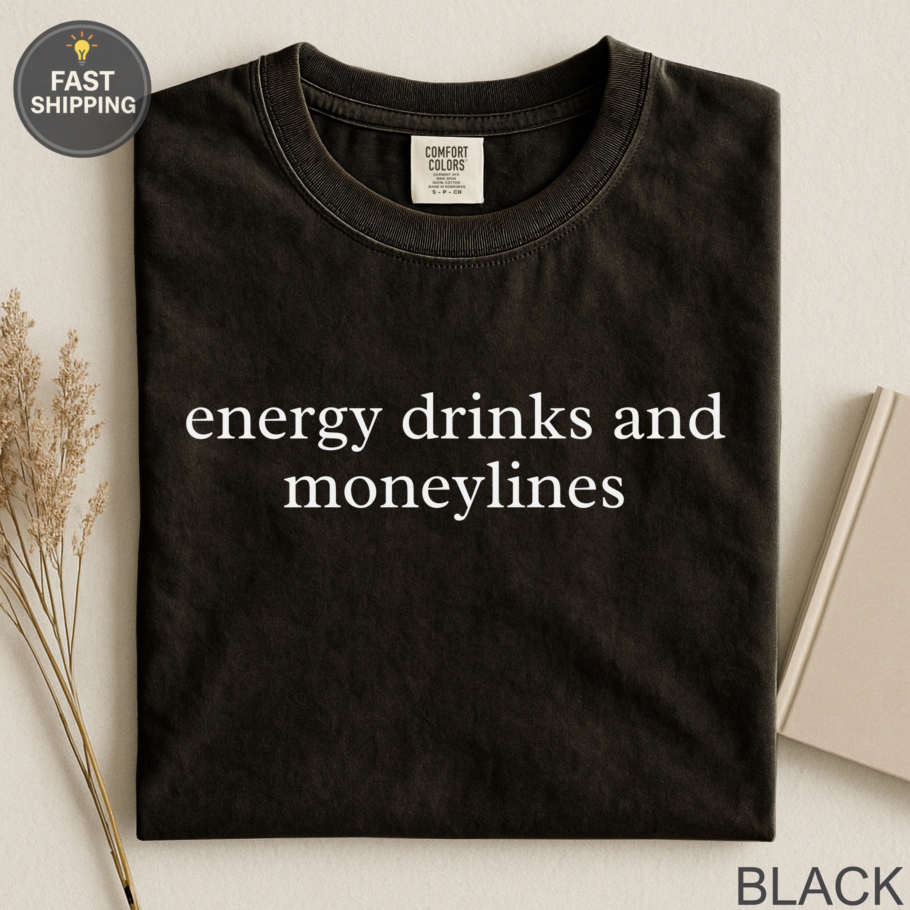 Black t-shirt with "energy drinks and moneylines" text.