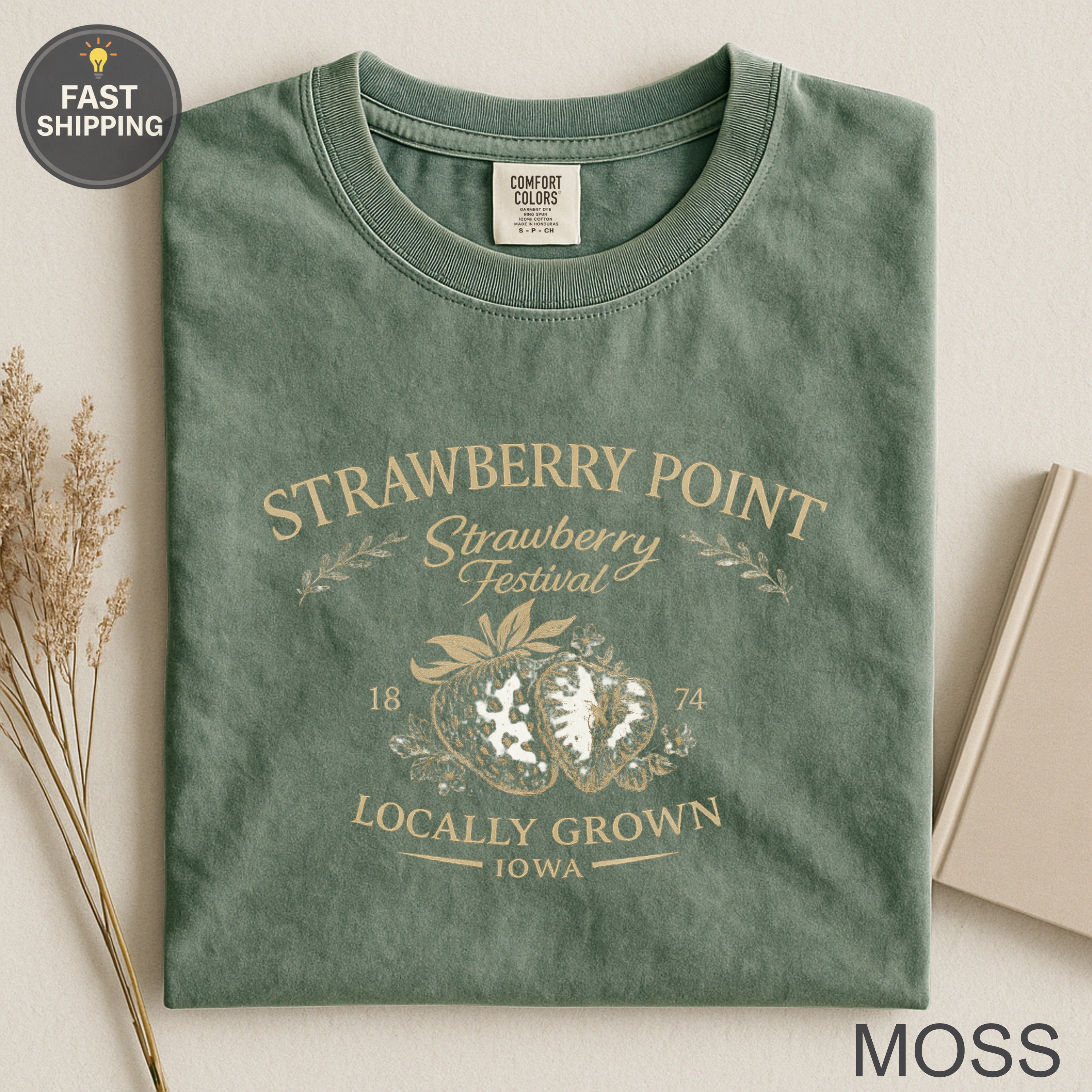 Green t-shirt for Strawberry Point Festival with strawberries and "18 74 Locally Grown Iowa" text.