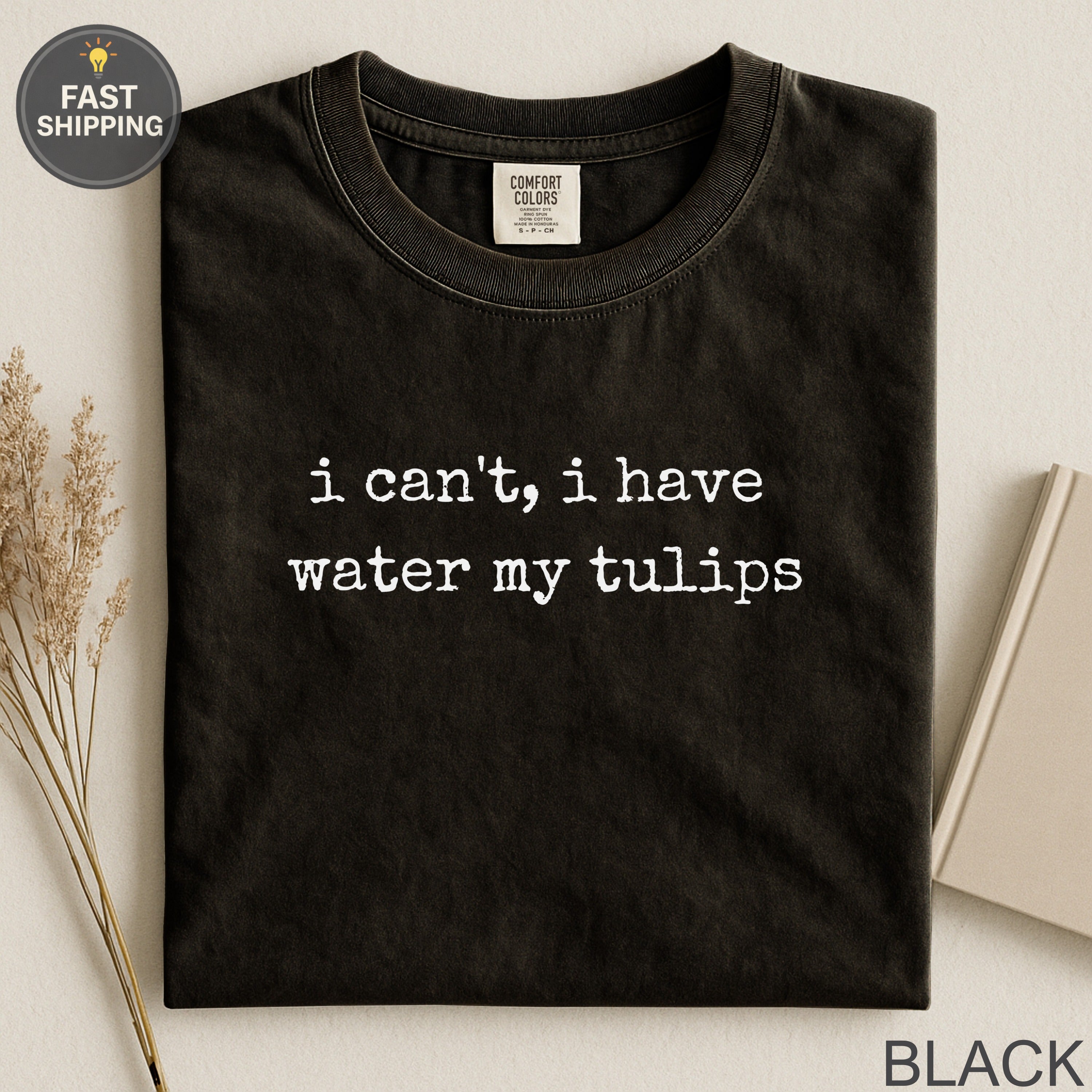 Black t-shirt with white text that reads "i can't, i have water my tulips".